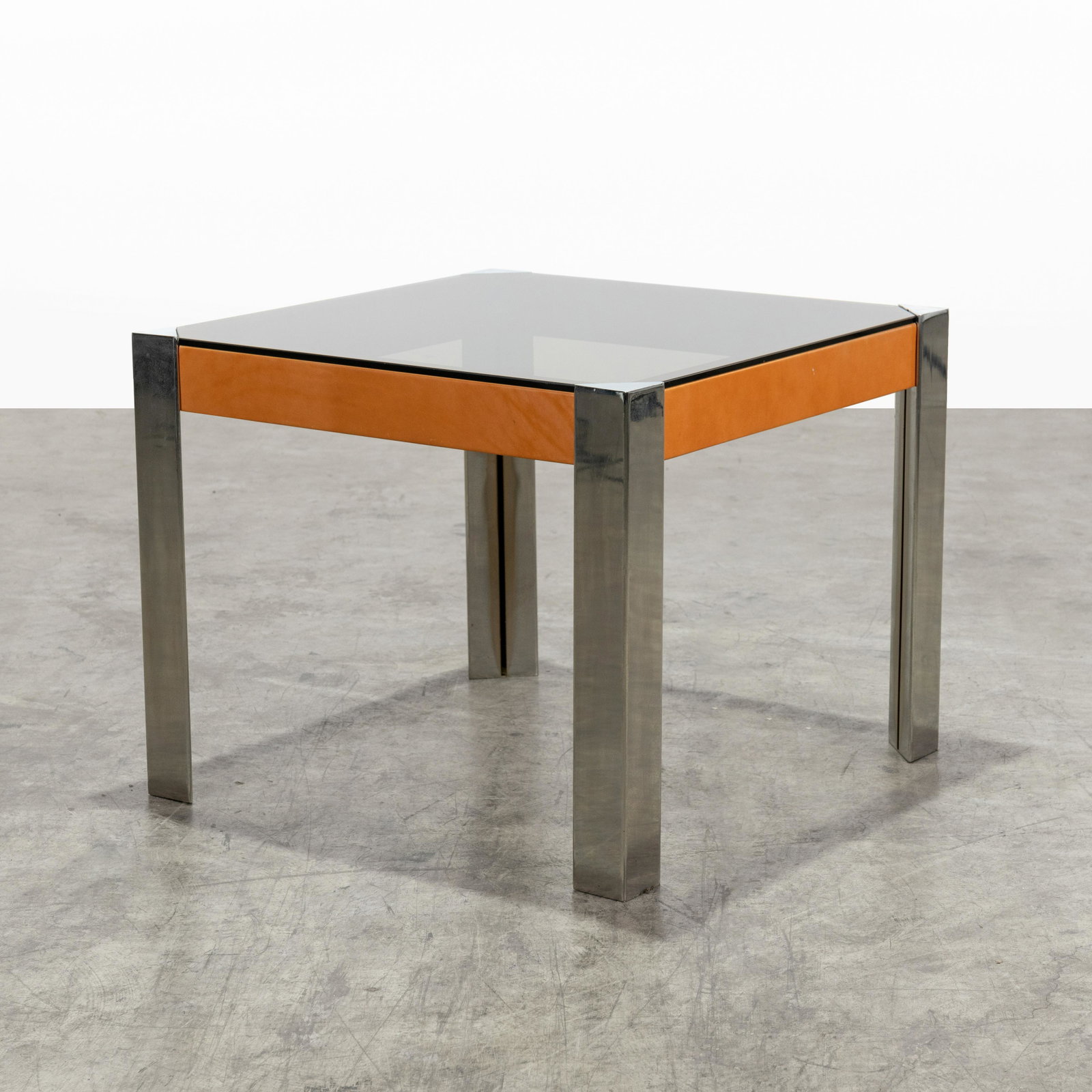 Guido Faleschini (Attr.) - Glass & Leather Table: A saddle leather, glass and chrome card table attributed to Guido Faleschini. 29" x 36" x 36" . All measurements are in inches.