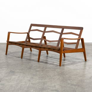 Arne Wahl Iversen - Teak Sofa: A unique three person sofa by Arne Wahl Iversen for Komfort in teak. With a rare and unique "diamond" form backrest and floating back leg. 27.5 x 72 x 32 . All measurements are in inches.