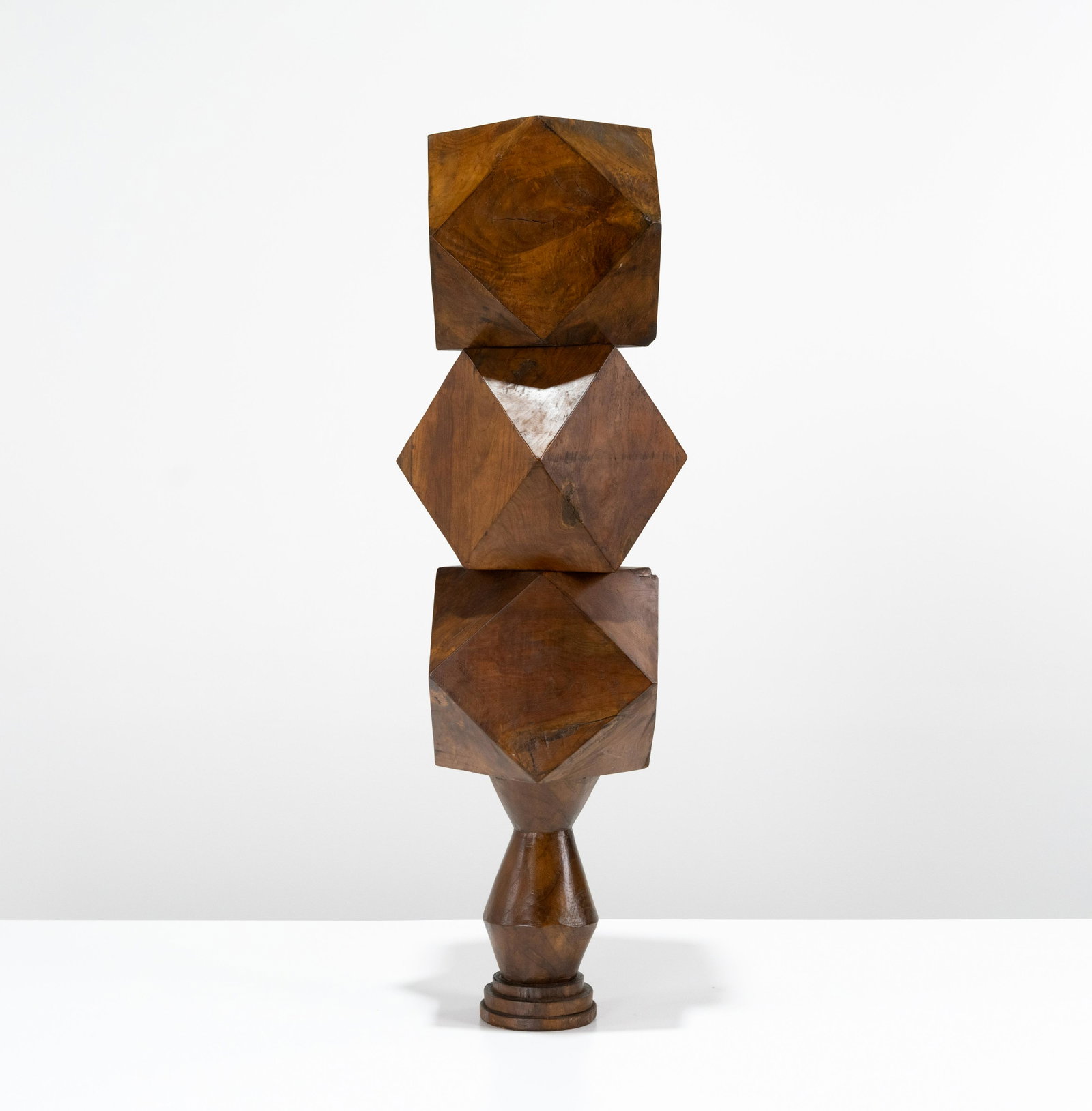 Stacked Faceted Walnut Balls: A group of three faceted walnut balls on a turned pedestal. Each with a hole going through to take a rod, but the rod is missing. Ball - 10 x 12 x 12 / Pedestal - 12 x 5.5 As shown - 42 x 10 x 12 . Al