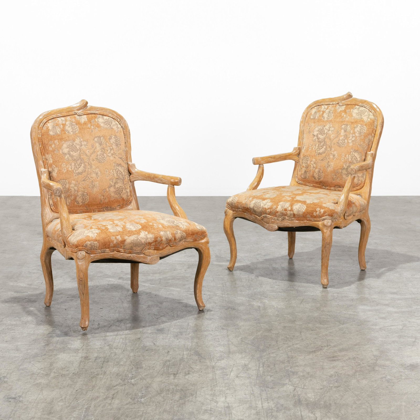 Faux Bois Arm Chairs: A pair of faux bois arm chairs. Wooden frames. 39" x 28" x 24" . All measurements are in inches.
