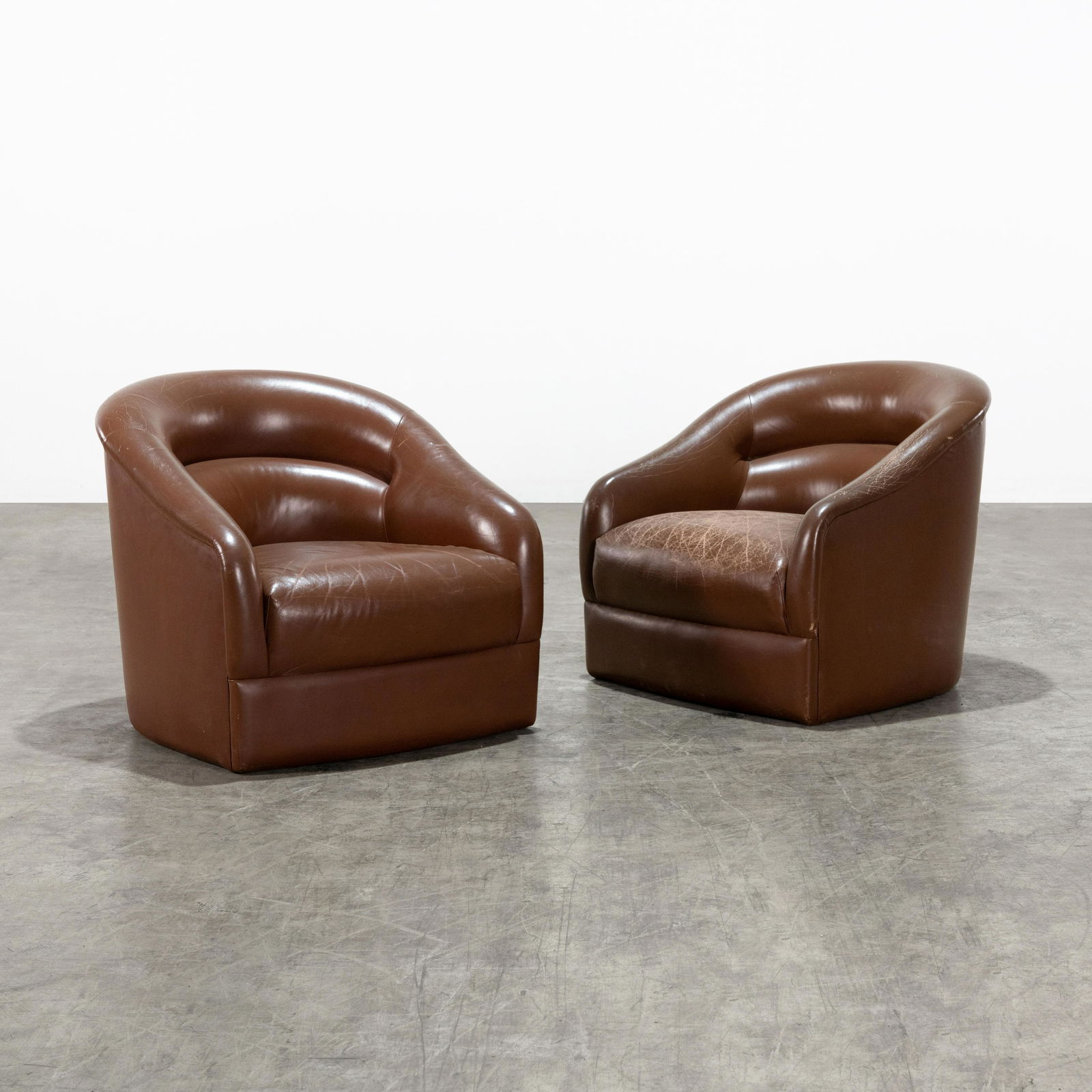 Leather Club Chairs: A pair of leather club chairs by David-Edward Company. Lacking original casters. 27 x 30 x 32 . All measurements are in inches.