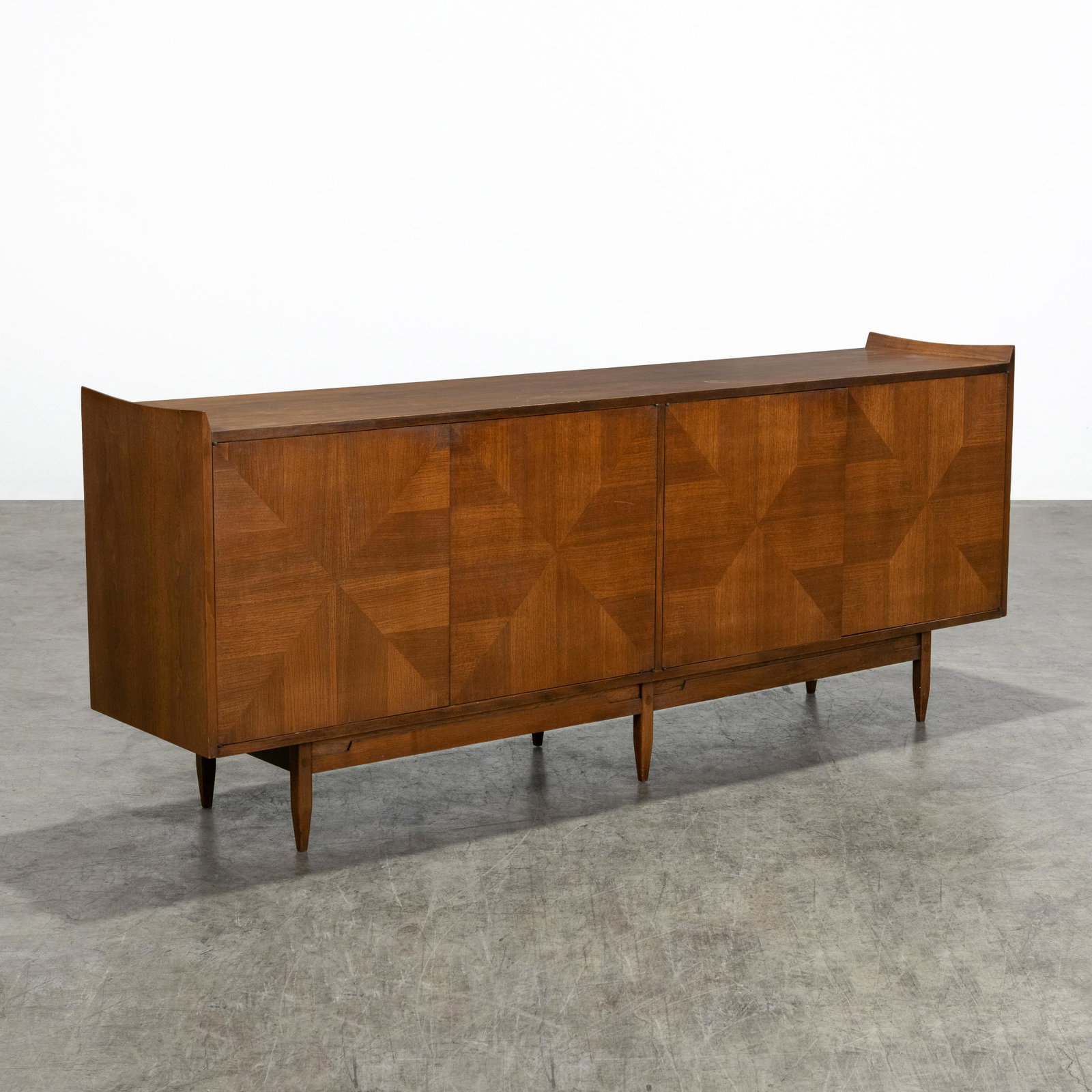 Walnut Credenza: A vintage walnut credenza with inlayed doors. Includes two shelves. Stains and wear to interior. 34 x 84 x 18.5