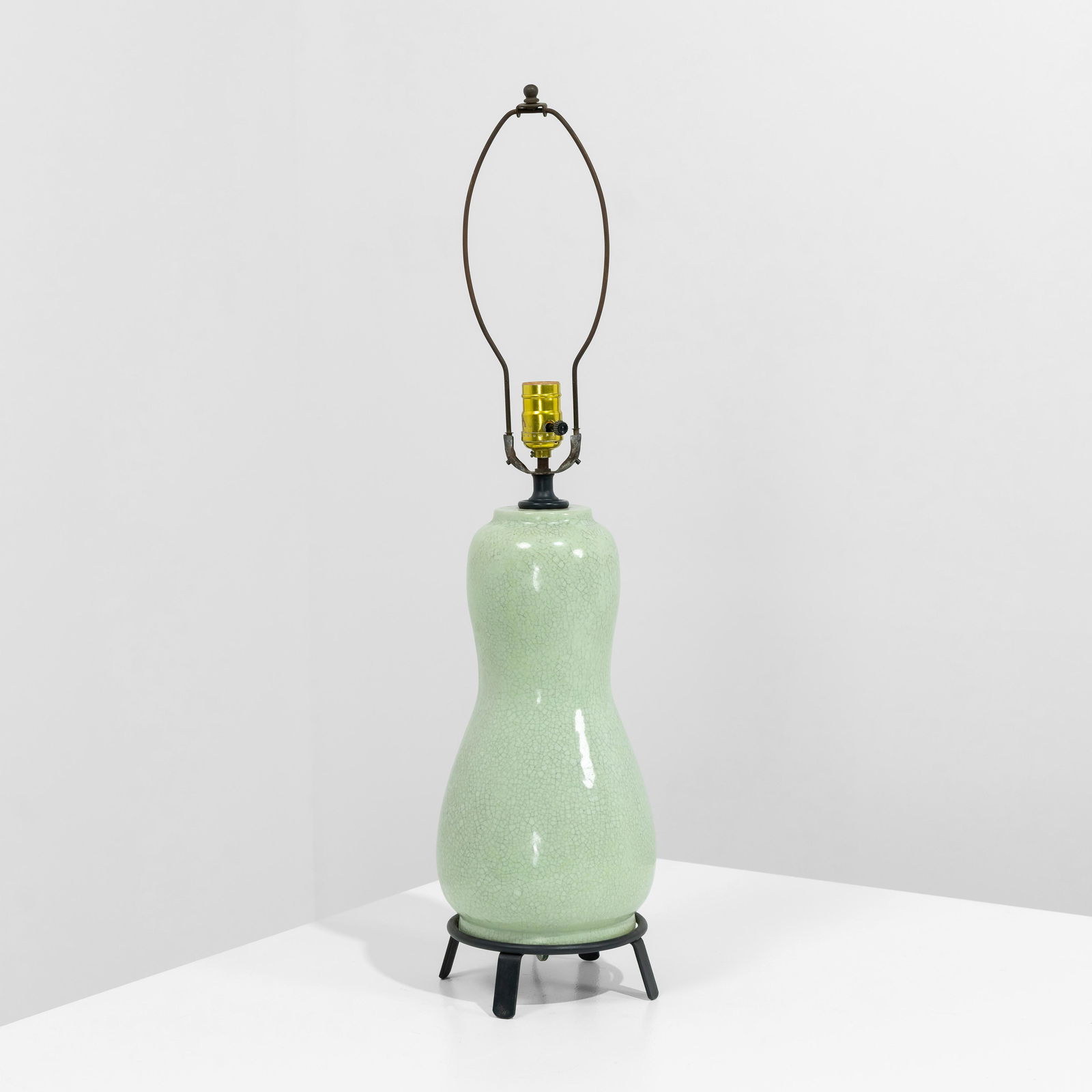 Ernestine of Salerno - Celadon Lamp: A glazed pottery lamp by Ernestine of Salerno on a steel base. Signed on underside. Body - 16.5 x 7.5 . Measurements are in inches. (Height x Width x Depth)