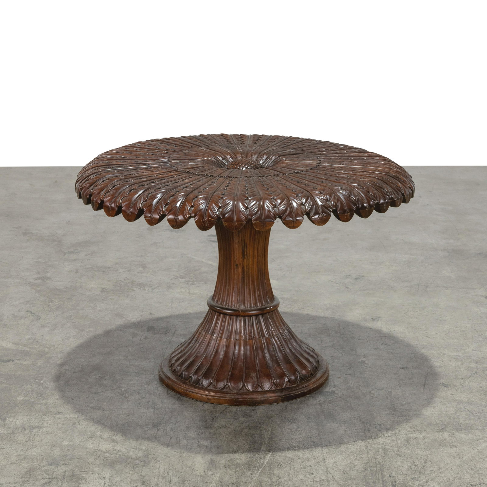 Flower Carved Center Table: A flower carved mahogany center table. 29 x 43 Measurements are in inches. (Height x Width x Depth)