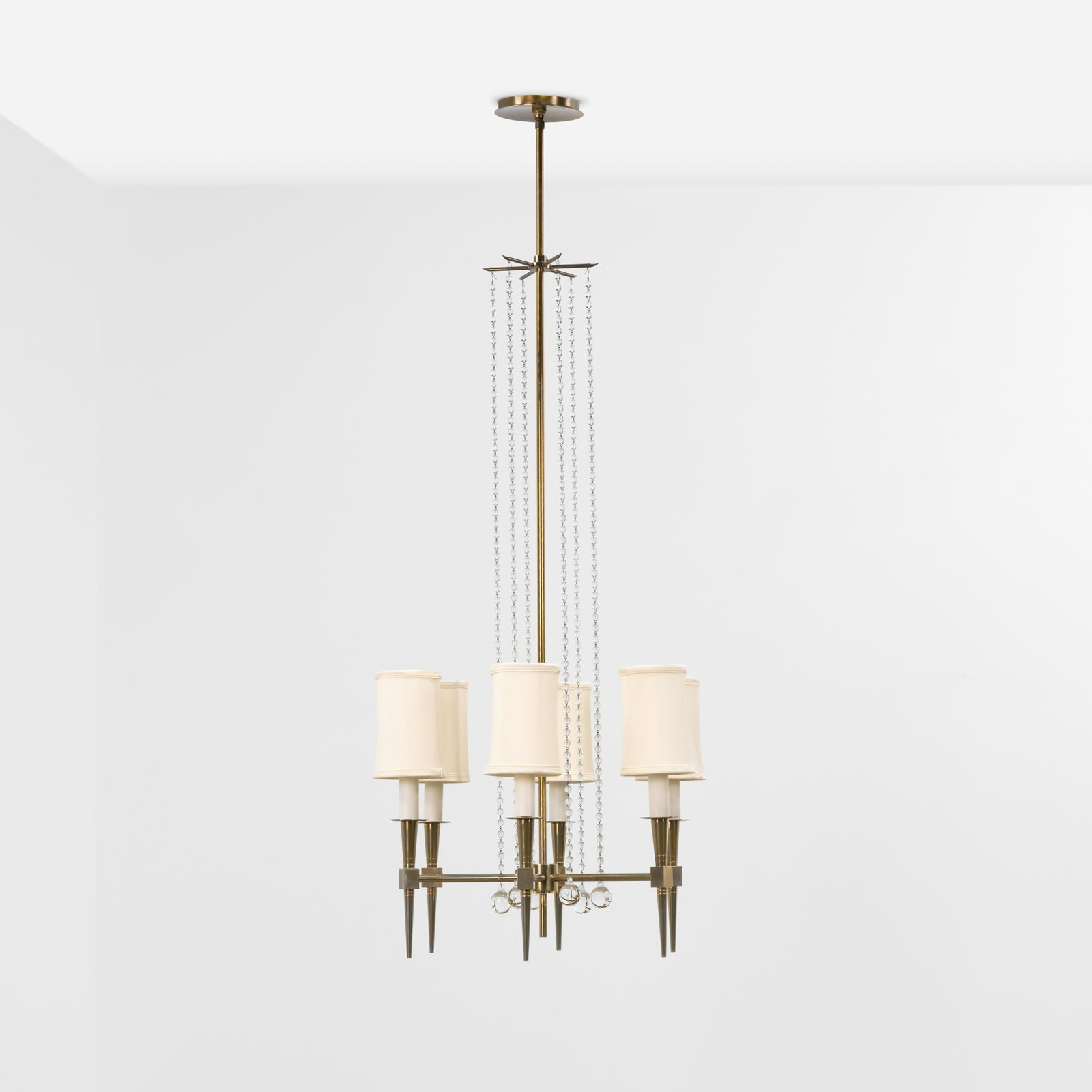 Tommi Parzinger - Brass Chandelier: A Tommi Parzinger brass and crystal chandelier. With new silk shades. Referenced in a hand drawn Tommi Parzinger catalog with corresponding drawing numbered #1. 55 x 21 x 21 Measurements are in inches