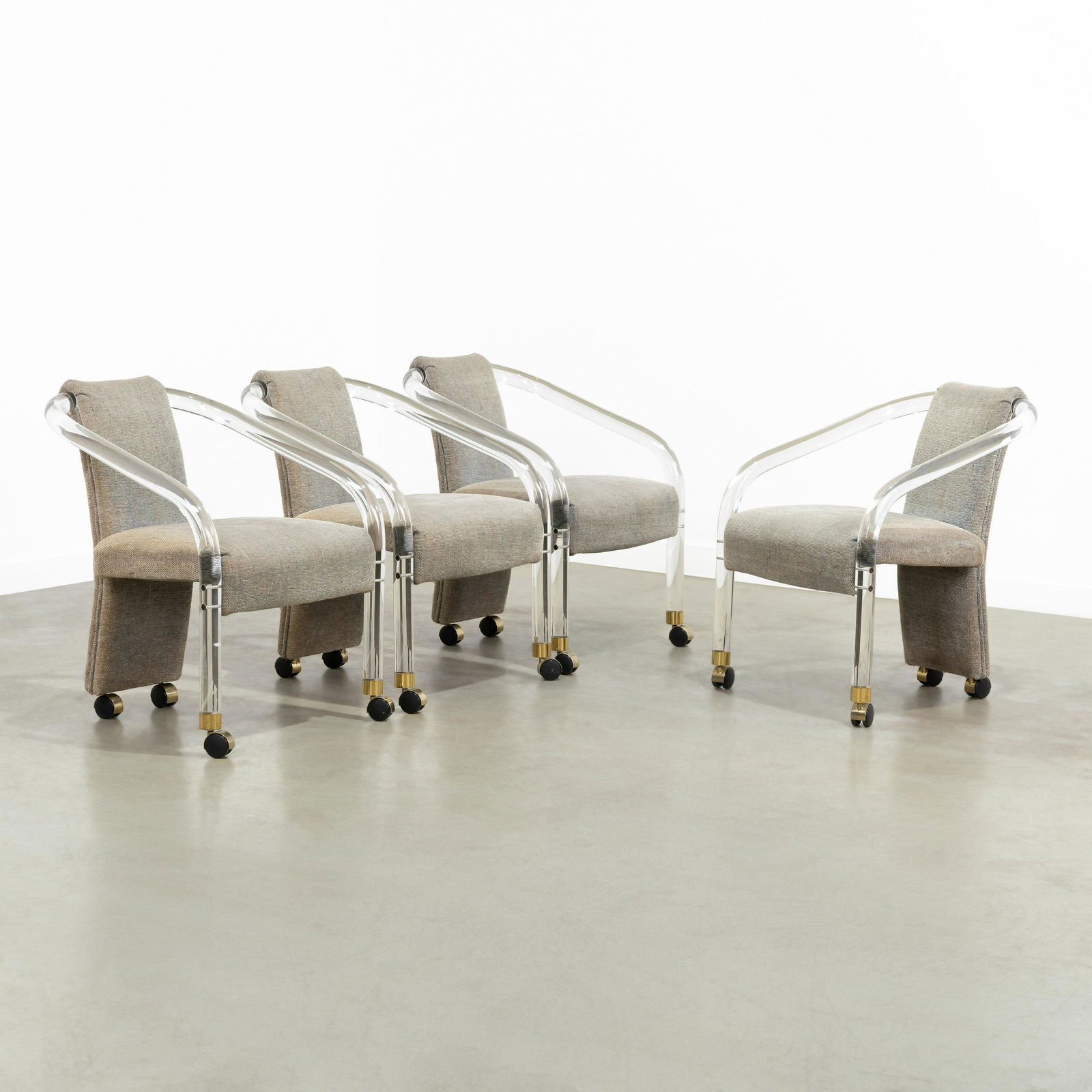 Charles Hollis Jones (Attr.) - Chairs: A set of four lucite chairs on casters, attributed to Charles Hollis Jones. 28.5 x 22 x 24. Measurements are in inches. (Height x Width x Depth)