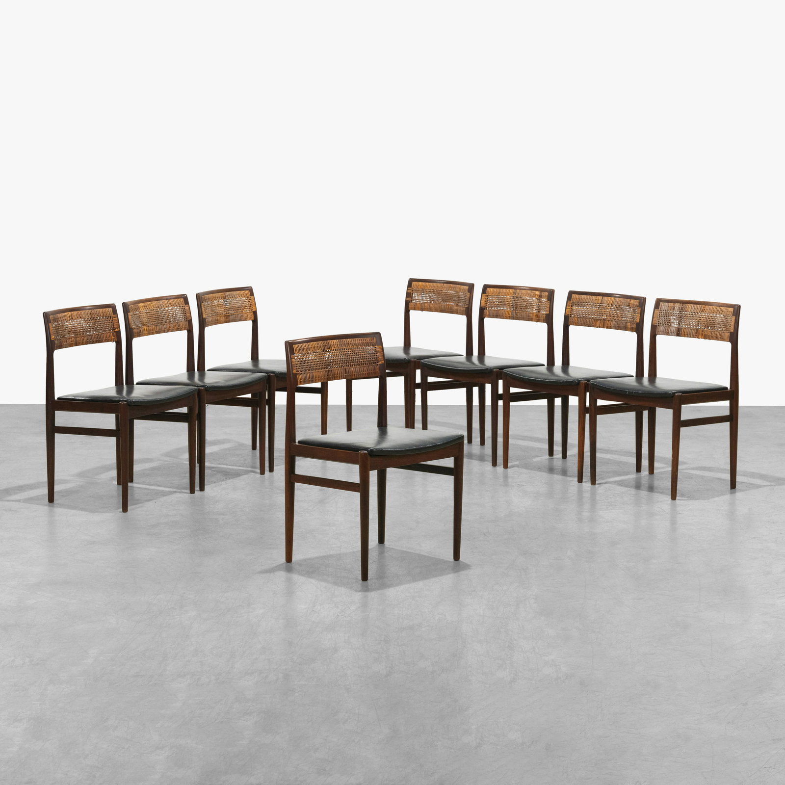 Erik Worts - Rosewood Dining Chairs: A set of eight rosewood dining chairs with black leather seats by Erik Worts for Henrik Worts Mobelsnedkeri, Denmark. 30.5 x 19.5 x 18. All measurements are in inches.