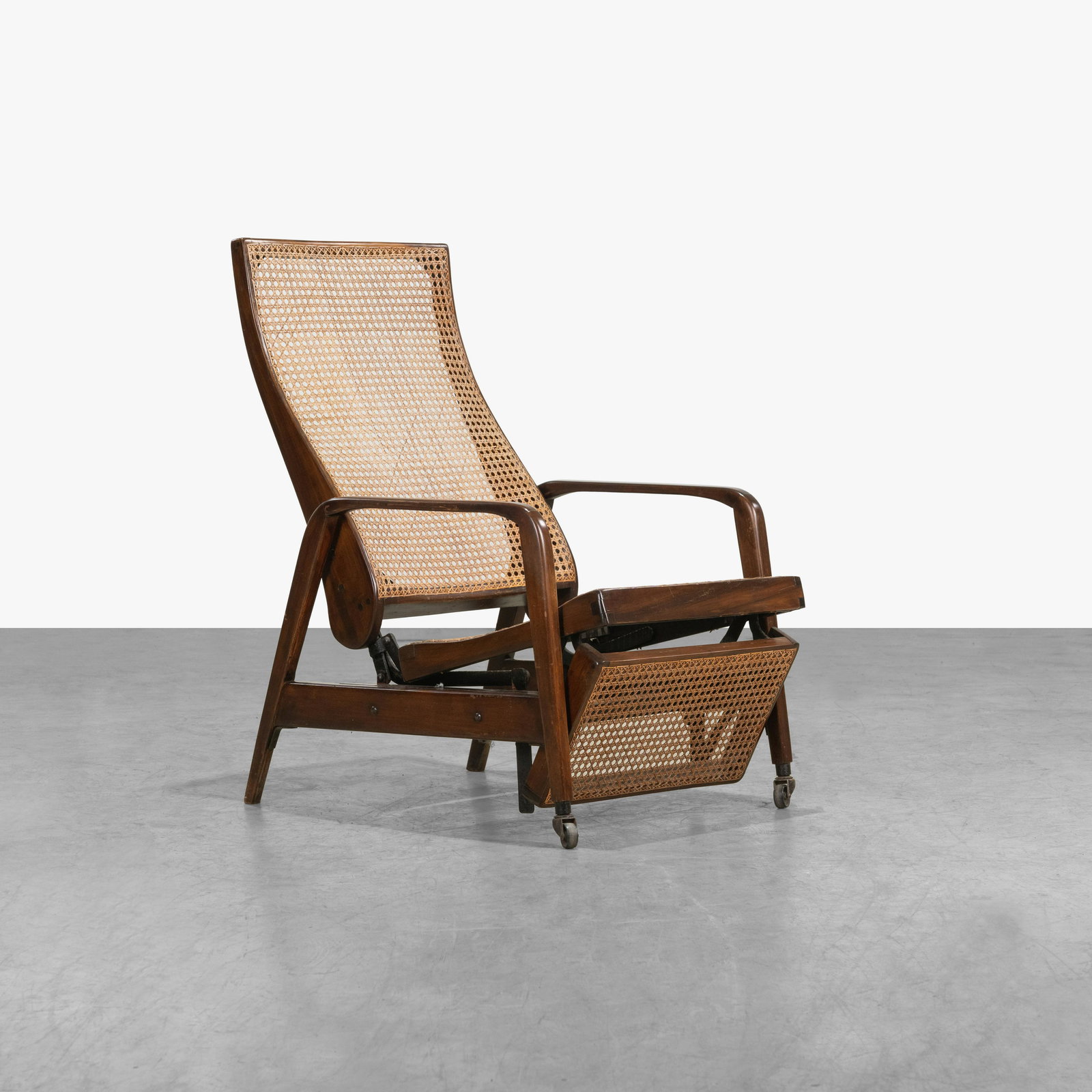 Mechanical Caned Recliner: A Brazilian caned recliner. 38 x 24 x 30. All measurements are in inches.