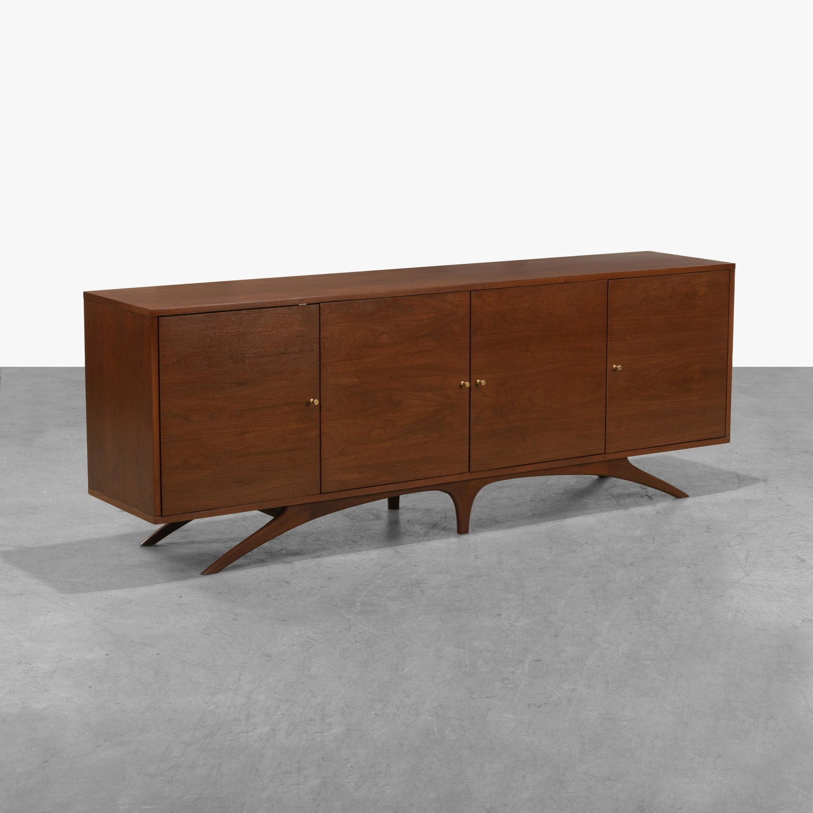 Vladimir Kagan (After) - Credenza: A vintage walnut credenza in the manner of Vladimir Kagan. 30.5 x 84 x 17.5. All measurements are in inches.