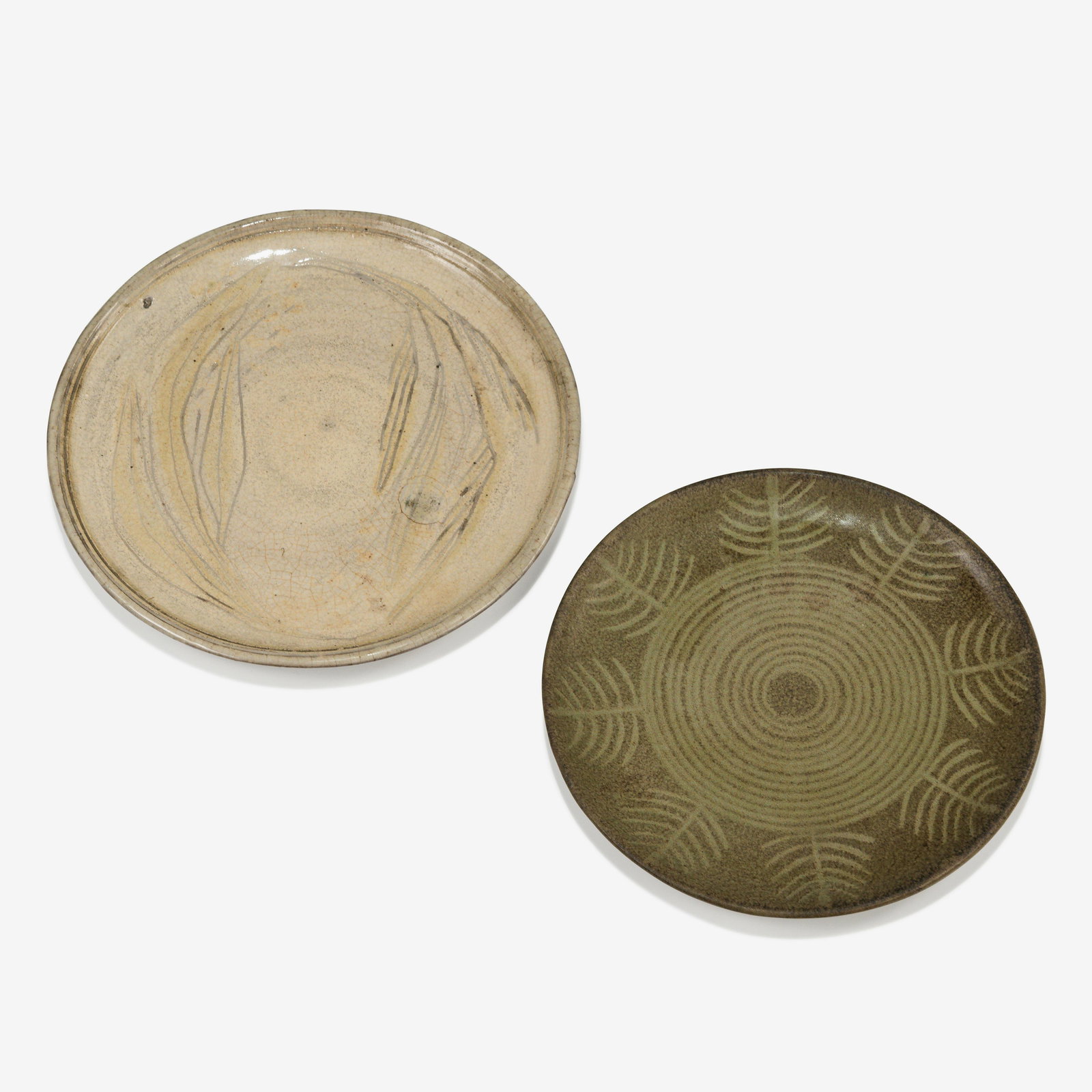 Nancy Wickham - Stoneware Plates: Two stoneware plates by Nancy Wickham for Design-Technics. One with incised plant leaves, signed on bottom, and another with glaze decorated leafs, stamped on bottom, 'Design-Technics'. Larger - 11.25