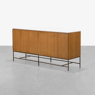 Paul McCobb - Credenza: A vintage credenza with tri-fold doors by Paul McCobb for Calvin Furniture's 'Irwin' Collection. With original Vitrolite glass top. 34.5 x 74.5 x 19. Measurements are in inches. (Height x Width x