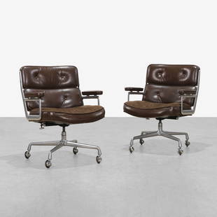 Charles & Ray Eames - Time Life Chairs: A pair of of 'Time Life' office chairs by Charles and Ray Eames for Herman Miller with leather and fabric upholstery. 34 x 29 x 22. Measurements are in inches. (Height x Width x Depth)