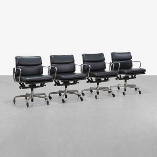 Charles & Ray Eames - Softpad Chairs: A set of four leather 'Softpad' chairs by Charles and Ray Eames for Herman Miller. 32 x 23 x 26. Measurements are in inches. (Height x Width x Depth)