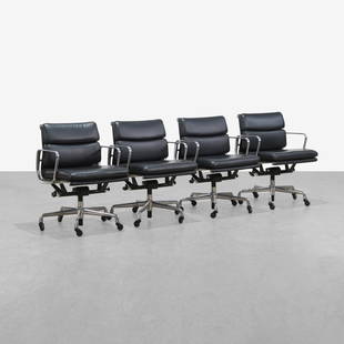 Charles & Ray Eames - Softpad Chairs: A set of four leather 'Softpad' chairs by Charles and Ray Eames for Herman Miller. 2011 production. 32 x 23 x 26. Measurements are in inches. (Height x Width x Depth)