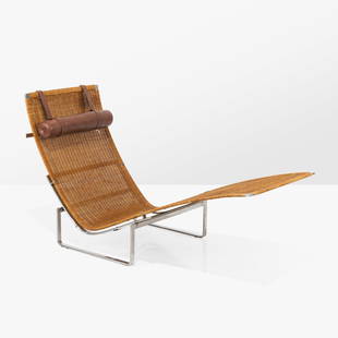 Poul Kjaerholm - PK24 Chaise Lounge: A steel and wicker chaise lounge by Poul Kjaerholm with leather head cushion. Early production. 33 x 60 x 26.5. Measurements are in inches. (Height x Width x Depth)