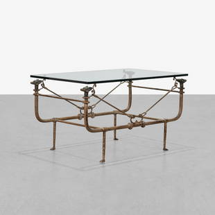 Diego Giacometti (After) - Coffee Table: A hammered iron coffee table with dog head finials and glass top by Paul Ferrante, in the manner of Diego Giacometti. 22.5 x 42.5 x 27. Measurements are in inches. (Height x Width x Depth)