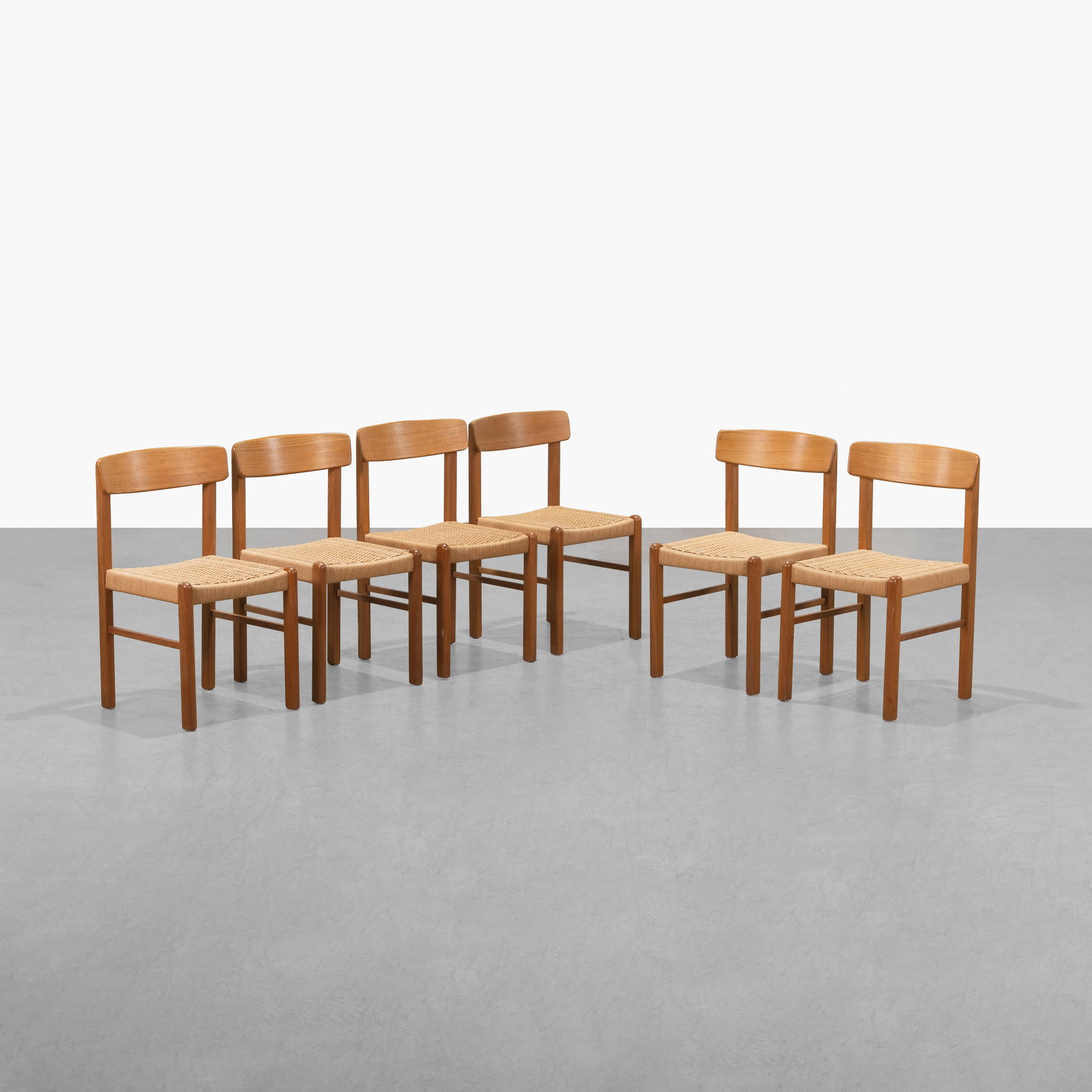 Teak and Rope Dining Chairs: A set of six teak and rope dining chairs. Possibly Danish. Unmarked. 32 x 19.5 x 18.5. Measurements are in inches. (Height x Width x Depth)