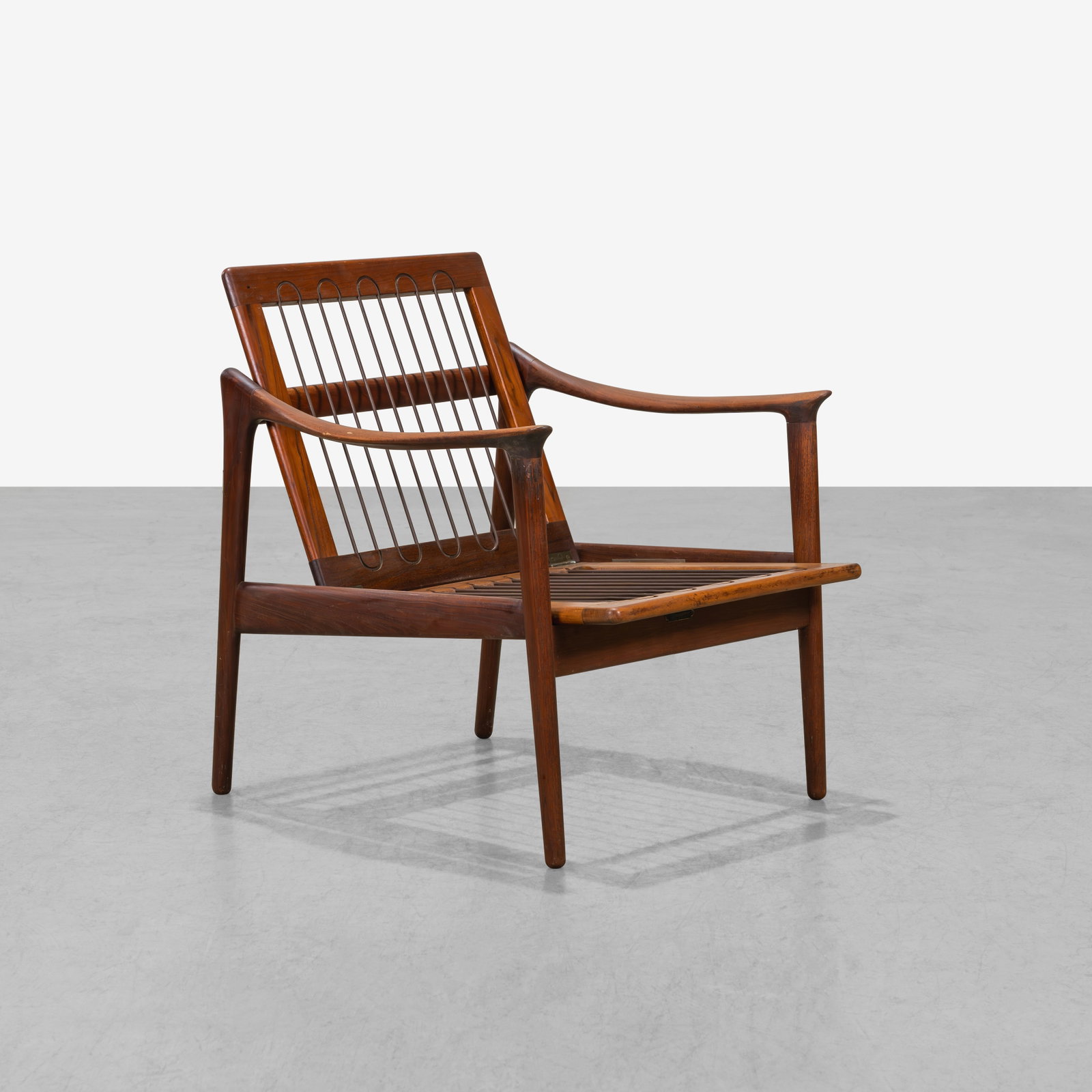 Danish Lounge Chair: A vintage teak lounge chair. 29.5 x 26.5 x 29. All measurements are in inches. (Height x Width x Depth).