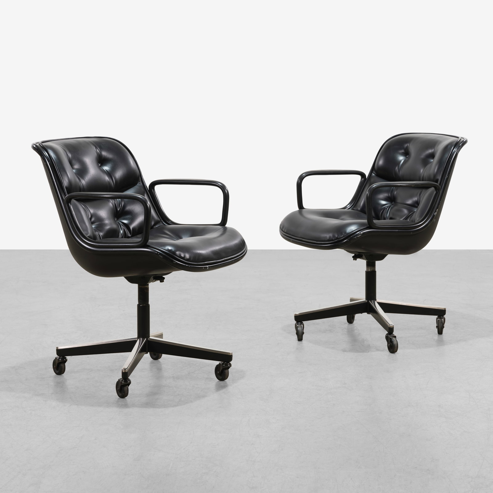 Charles Pollock - Executive Chairs: A pair of 'Executive' chairs by Charles Pollock for Knoll in black leather. 34 x 26.5 x 26. All measurements are in inches. (Height x Width x Depth).