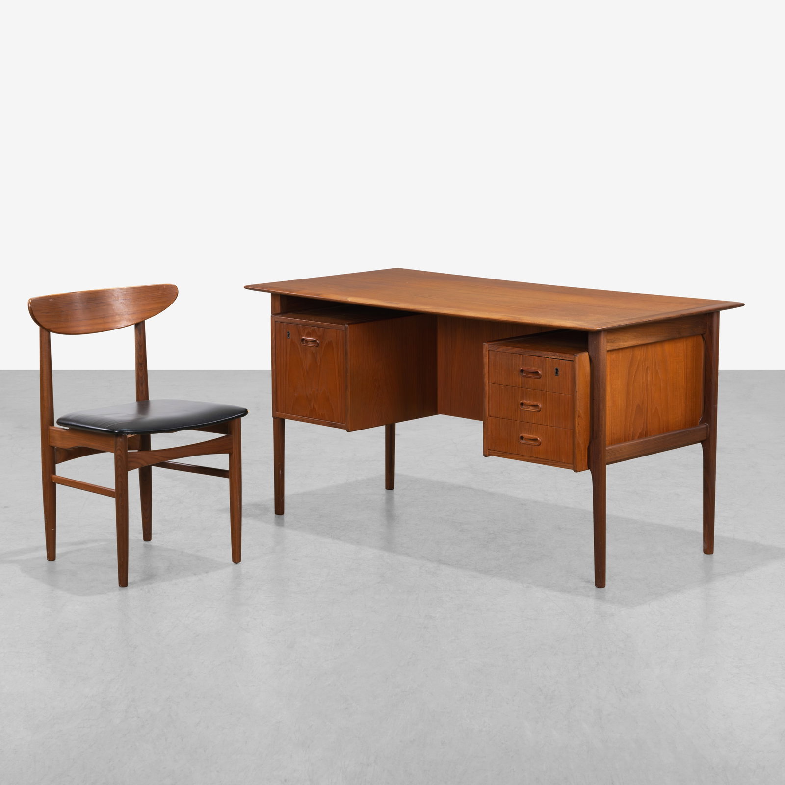 Teak Desk & Chair: A Danish teak desk and chair. 29 x 54 x 27. All measurements are in inches. (Height x Width x Depth).
