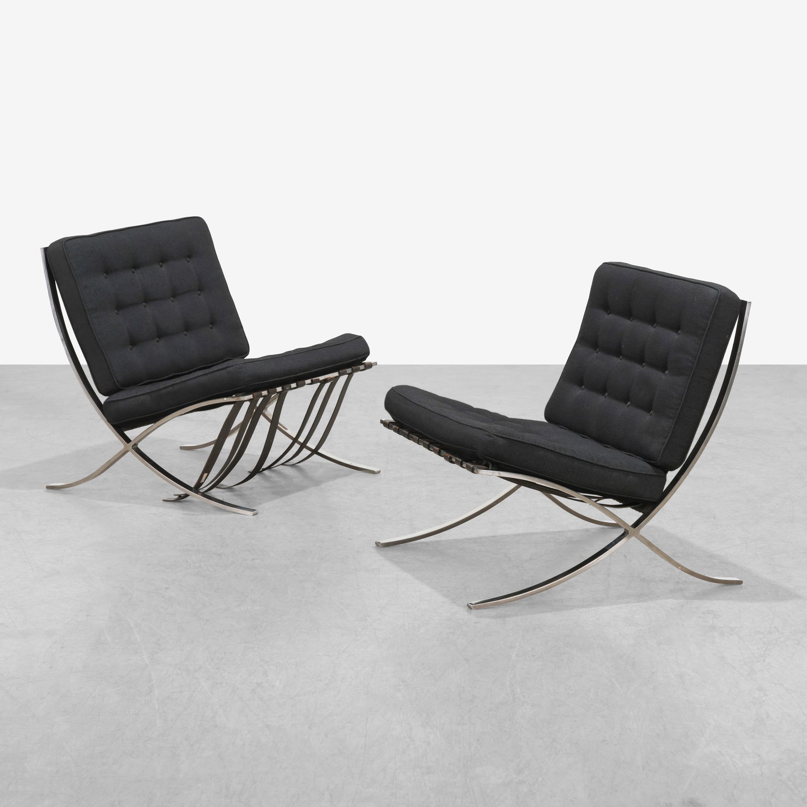 Mies Van Der Rohe - Barcelona Chairs: A pair of vintage 'Barcelona' chairs by Mies Van Der Rohe for Knoll. Retains Knoll labels and impressed 'KP' on frame.