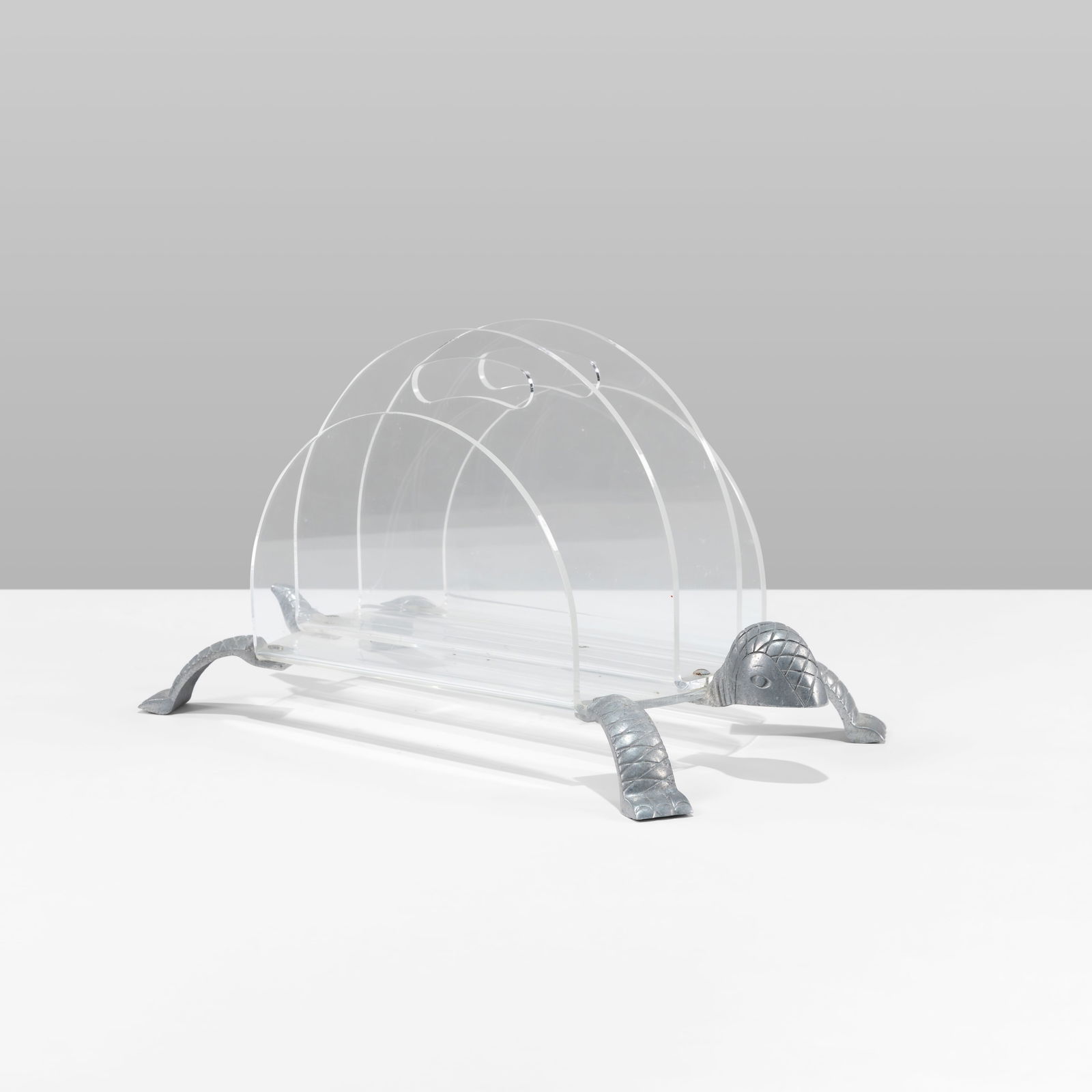 Arthur Court - Magazine Rack: A tortoise form lucite and aluminum magazine rack. All measurements are in inches. Height x Width x Depth