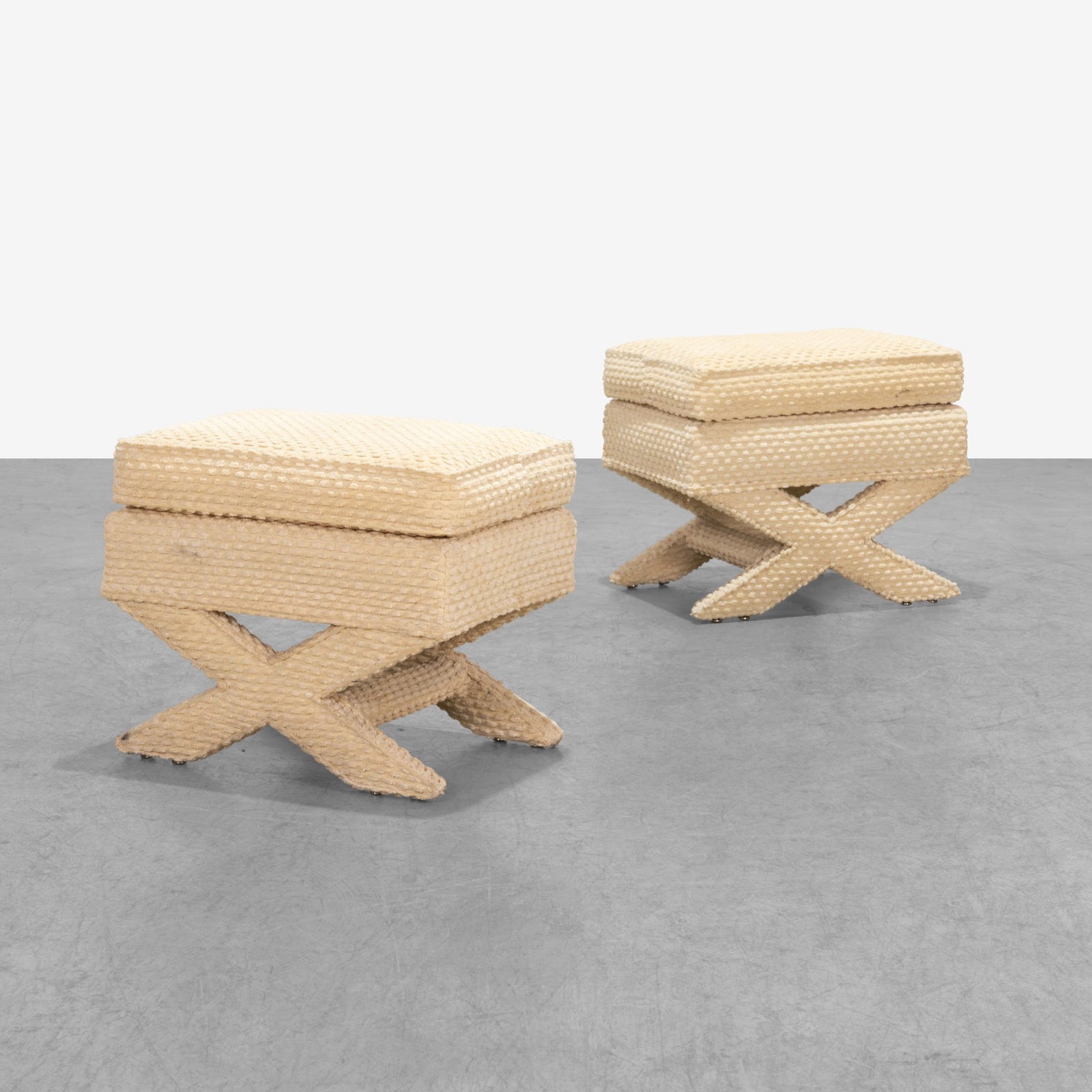 X-Base Ottomans: A pair of vintage 'X-Base' ottomans. All measurements are in inches. Height x Width x Depth