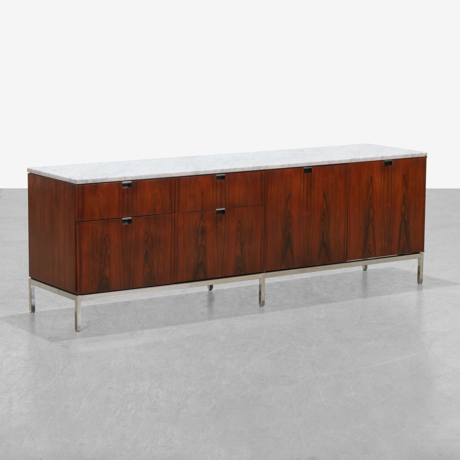 Florence Knoll - Rosewood Credenza: A marble top rosewood credenza by Florence Knoll with finished back. All measurements are in inches. Height x Width x Depth