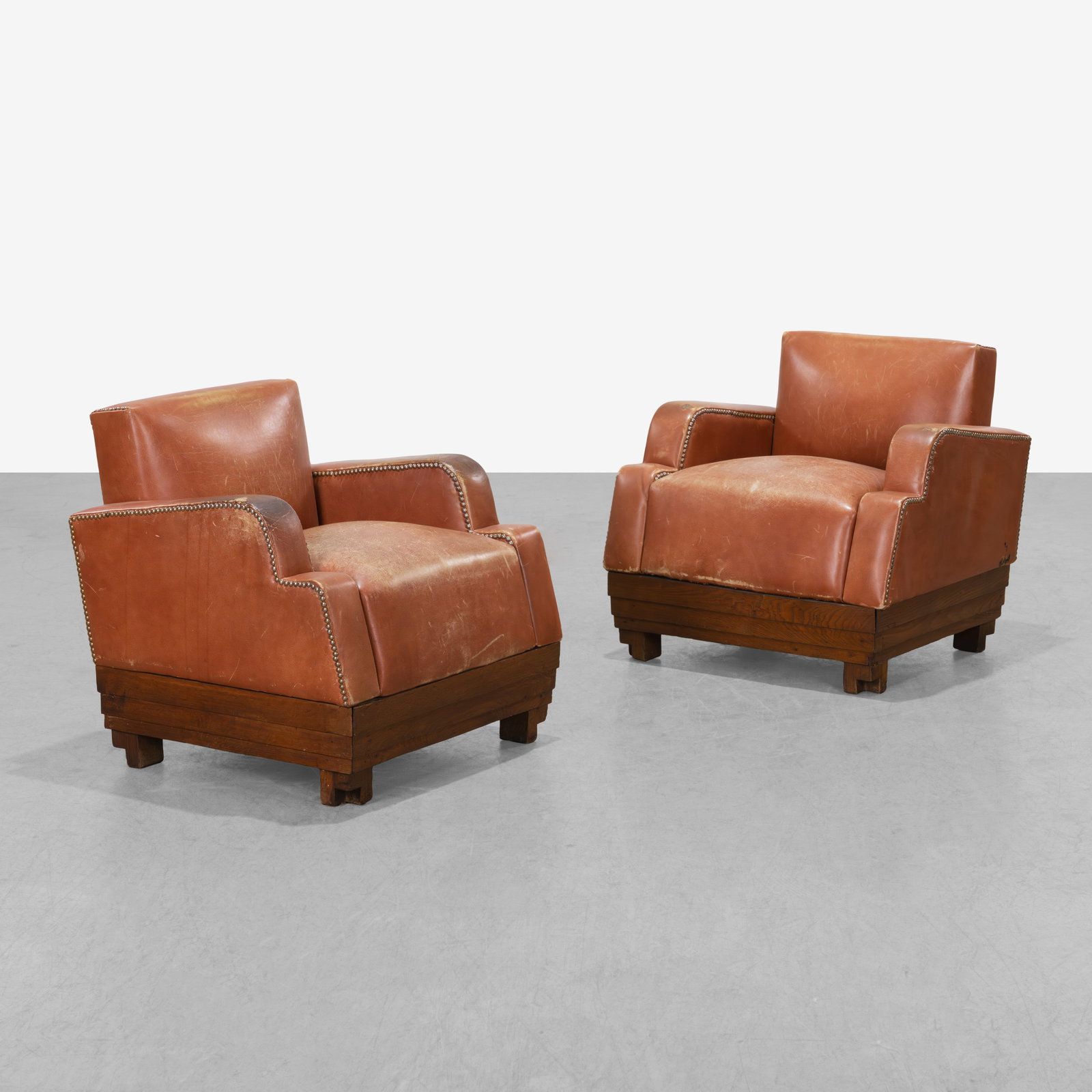 Art Deco Club Chairs: A pair of diminutive Art Deco club chairs in leather and oak with brass tacking. All measurements are in inches. Height x Width x Depth