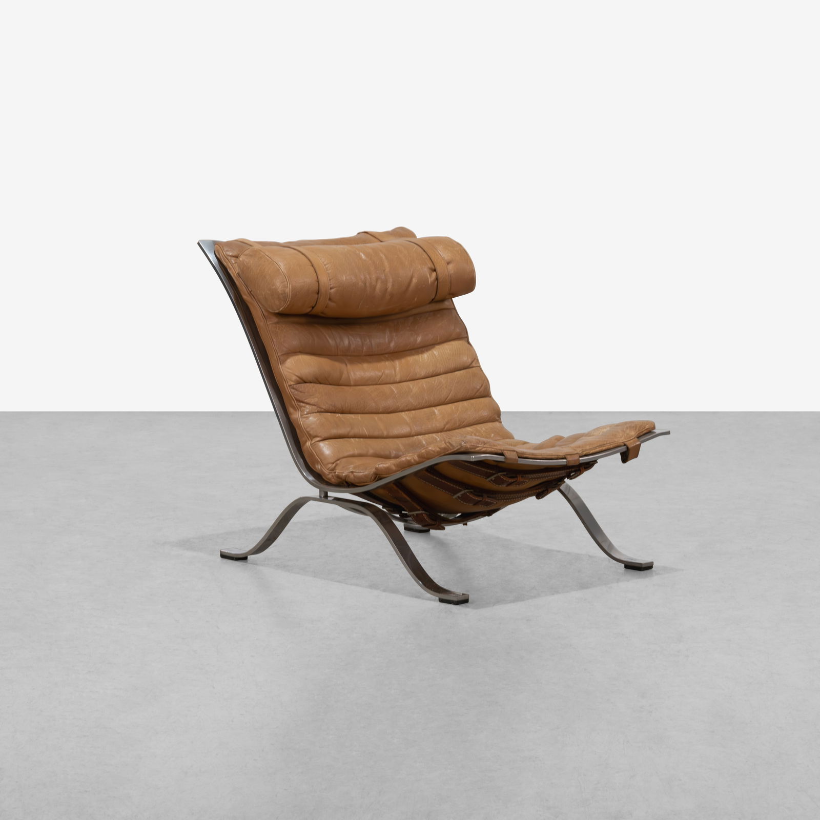 Arne Norell - Lounge Chair: A vintage, 'Ari' lounge chair by Arne Norell in leather and steel. All measurements are in inches. Height x Width x Depth