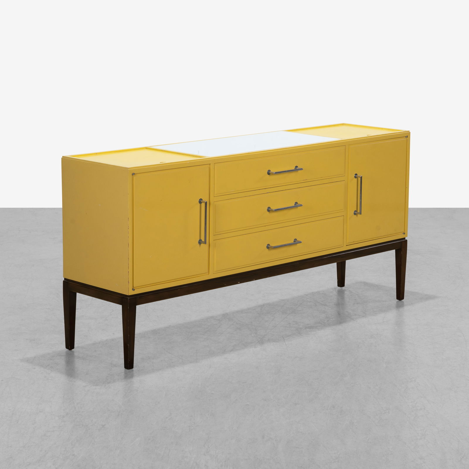 Tommi Parzinger (After) - Credenza: A vintage credenza in the manner of Tommi Parzinger in a yellow lacquer with glass inserts (Missing two smaller ones as shown.) All measurements are in inches. Height x Width x Depth