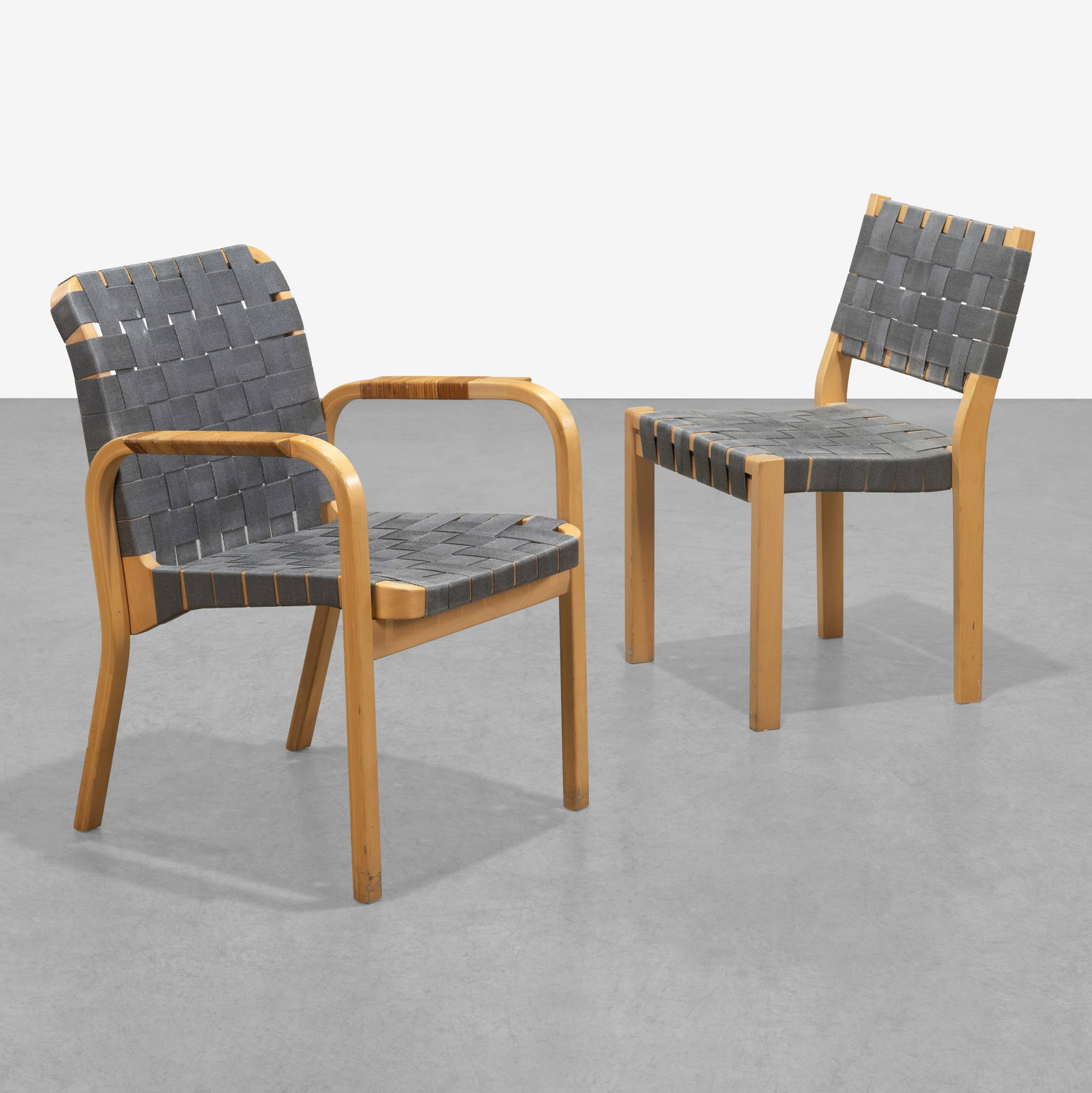 Alvar Aalto - Chairs: A model 45 armchair and matching side chair by Alvar Aalto. Lacking labels. Measurement is for armchair. All measurements are in inches. Height x Width x Depth
