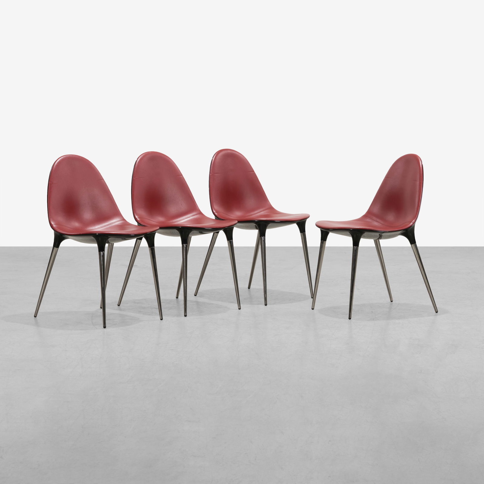 Philippe Starck - Caprice Chairs: A set of four leather 'Caprice' dining chairs by Philippe Starck. All measurements are in inches. Height x Width x Depth
