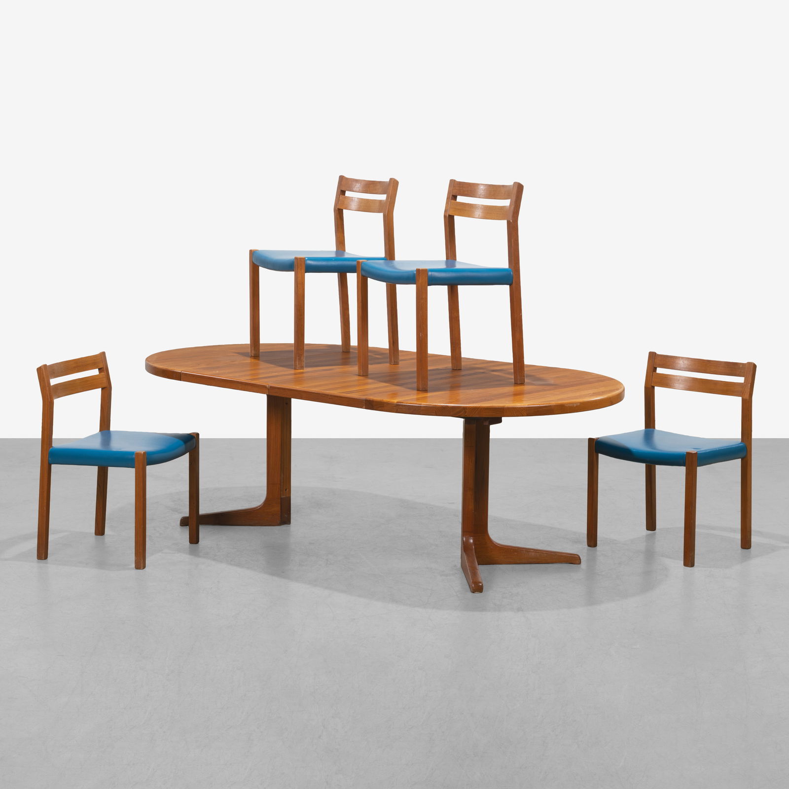 Danish Dining Table & Chairs: A vintage Danish teak dining table, by Glostrup, with two leaves and four J. L. Moller, teak dining chairs. Dimensions listed are for table with leaves out. Chair - 31 x 19.75 x 17.5. Tables leaves -