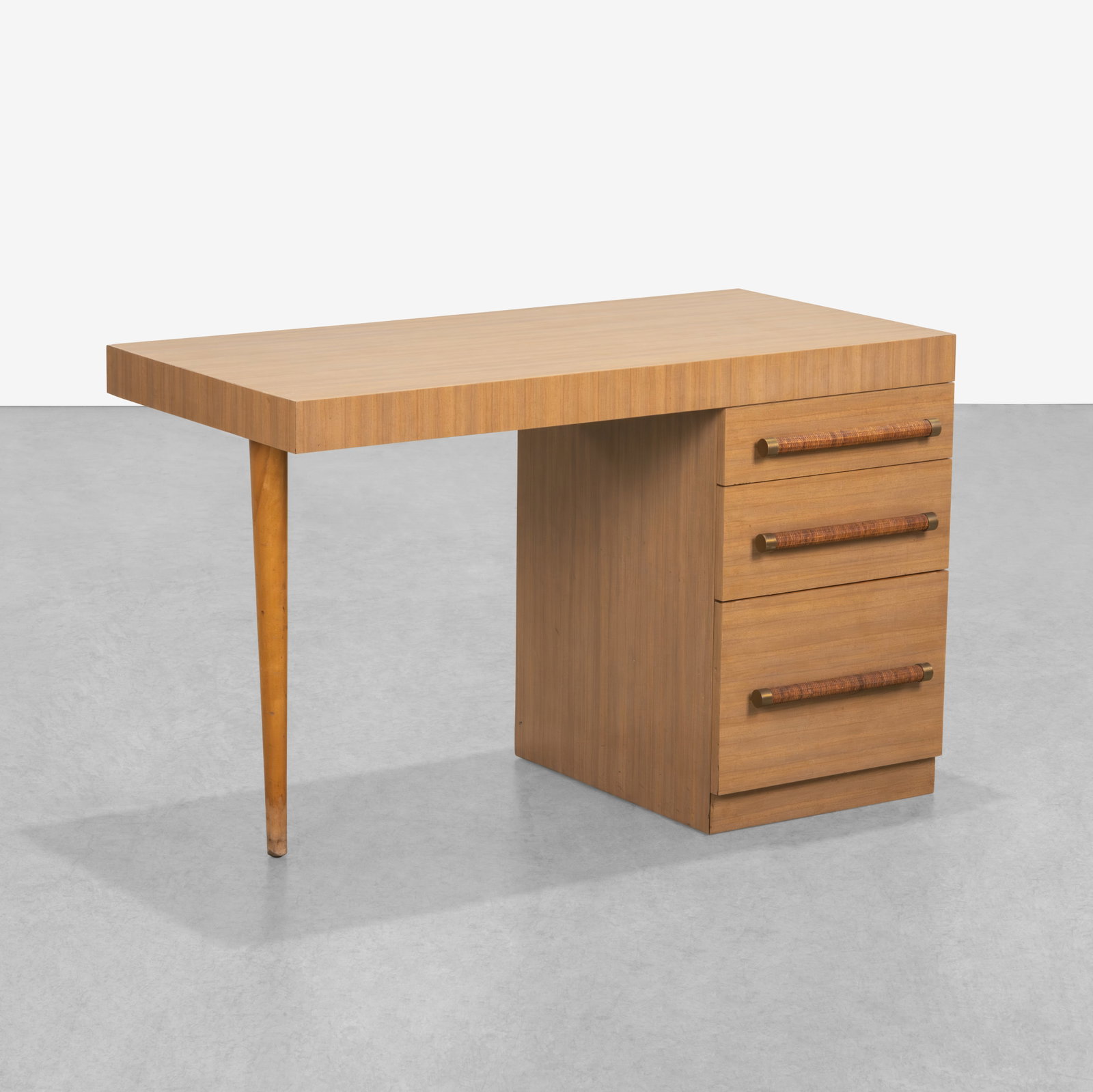 T. H. Robsjohn-Gibbings (After) - Desk: A laminated desk in the manner of T. H. Robsjohn-Gibbings. All measurements are in inches. Height x Width x Depth