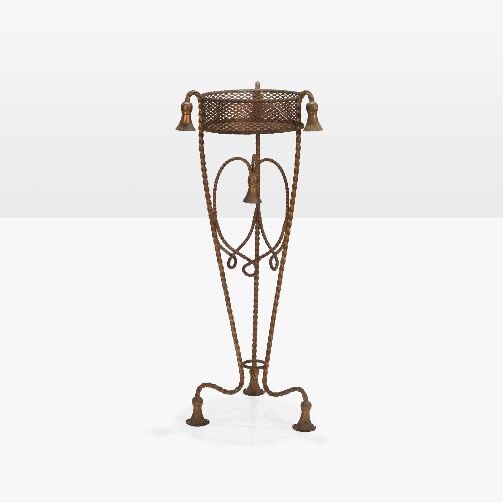 Gilt Metal Plant Stand: A gilt metal, rope tassel plant stand.