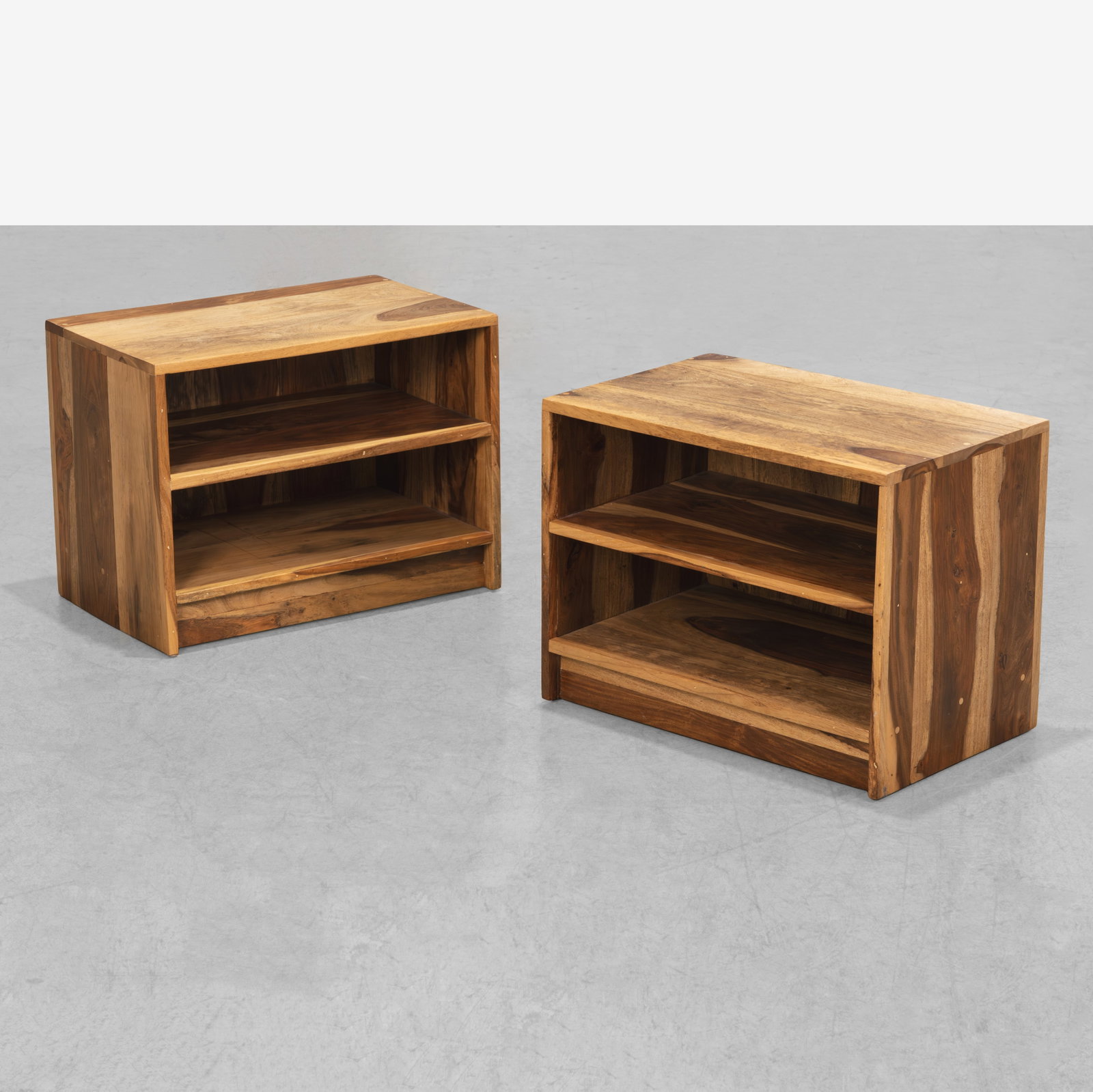 Indian Rosewood Nightstands: A pair of Indian rosewood nightstands with finished backs. All measurements are in inches. Height x Width x Depth