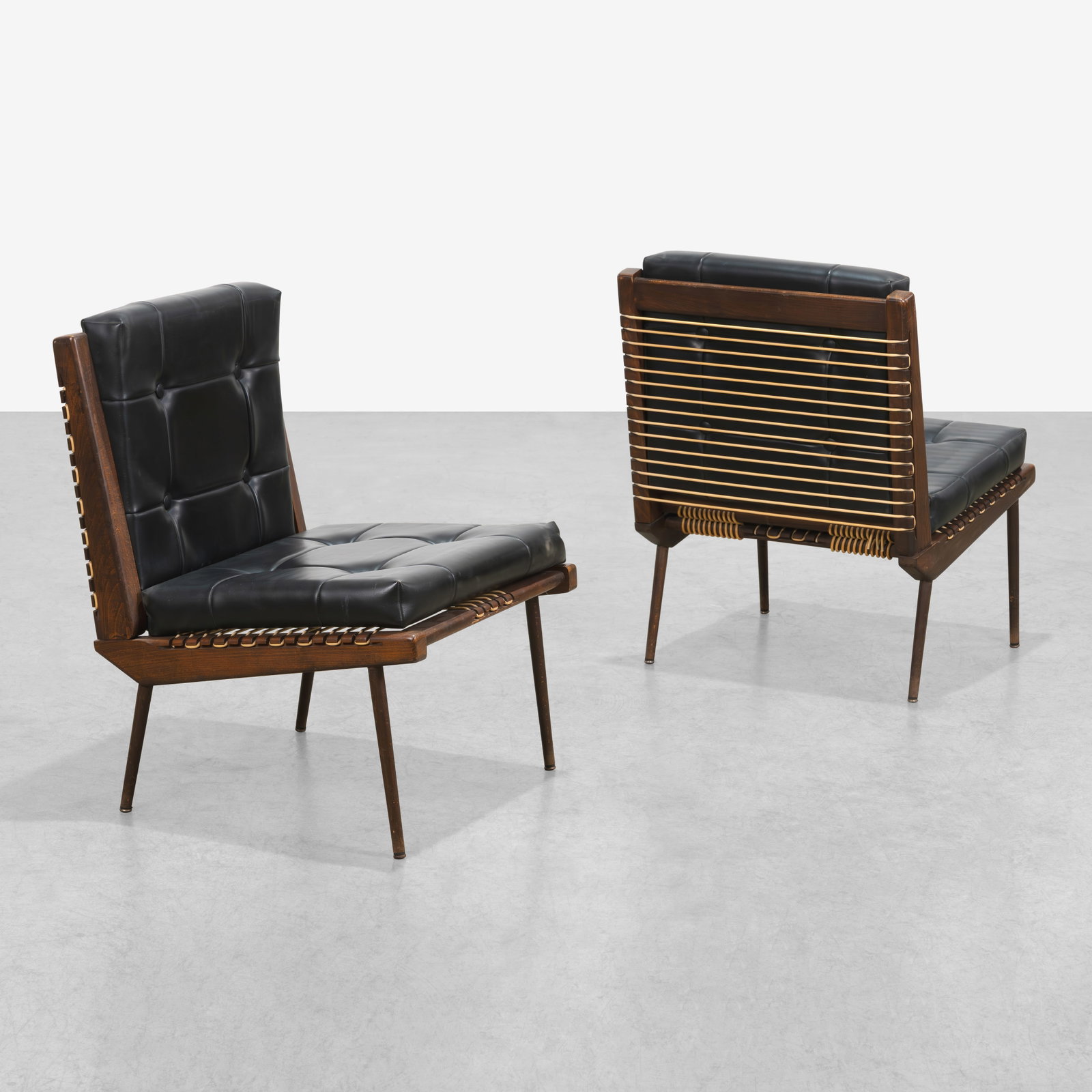 Georges Tigien - Lounge Chairs: A pair of vintage French lounge chairs by Georges Tigien with black Moleskin upholstered cushions. All measurements are in inches. Height x Width x Depth