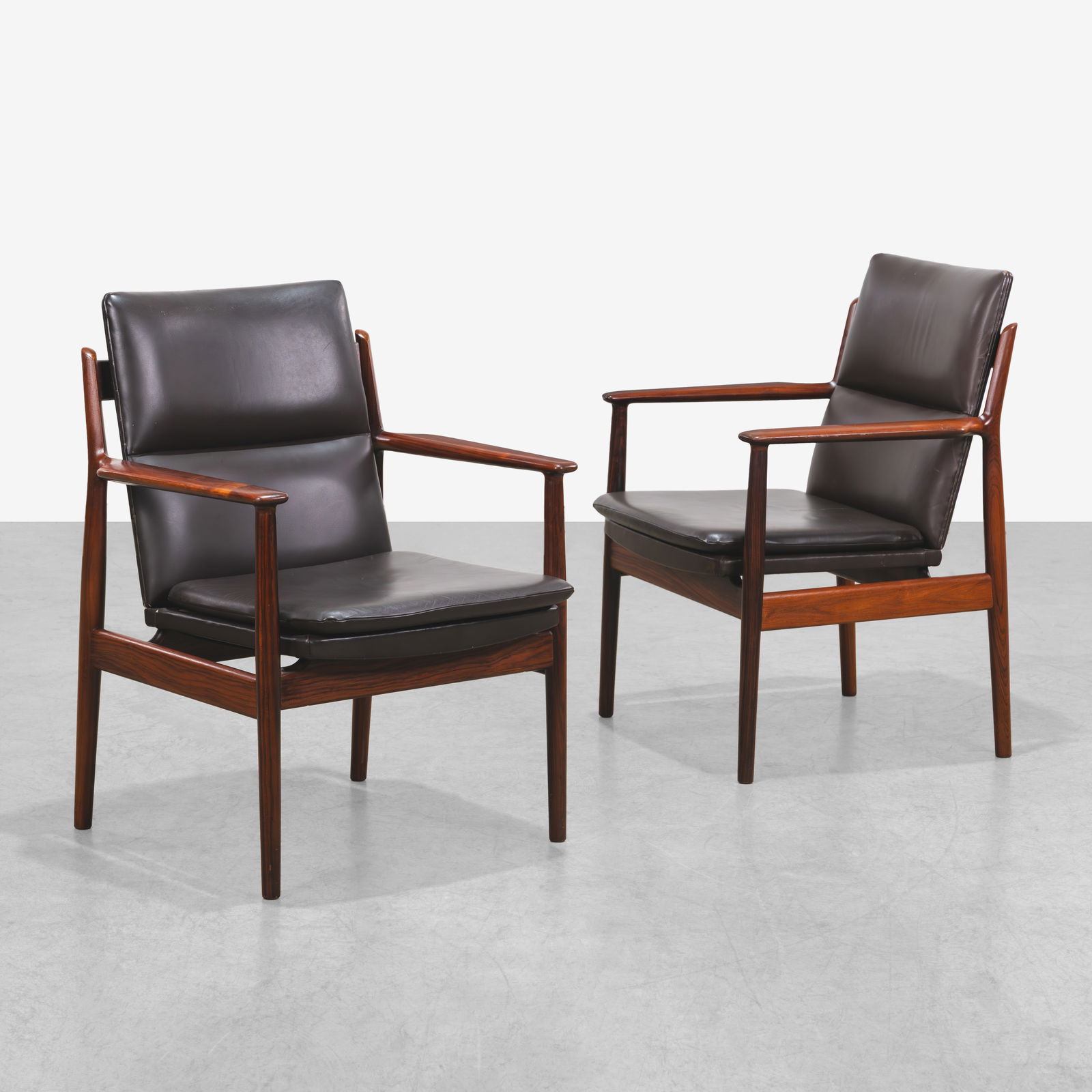 Arne Vodder - Armchairs: A pair of rosewood armchairs, Model 431, by Arne Vodder for Sibast, Denmark. All measurements are in inches. Height x Width x Depth