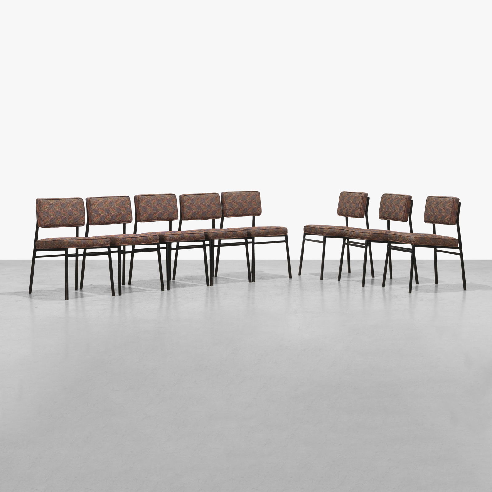 Modernist Dining Chairs: A set of eight modernist, steel framed dining chairs with floating backrests. In the manner of Florence Knoll. All measurements are in inches. Height x Width x Depth