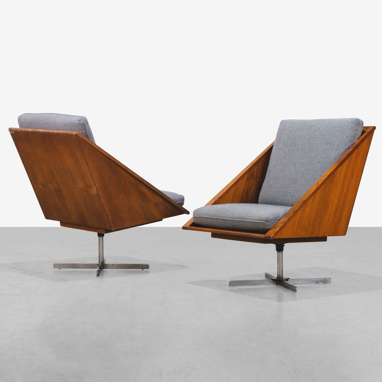 Walnut Lounge Chairs: A pair of angular walnut lounge chairs on chromed steel bases. Do not swivel. All measurements are in inches. Height x Width x Depth