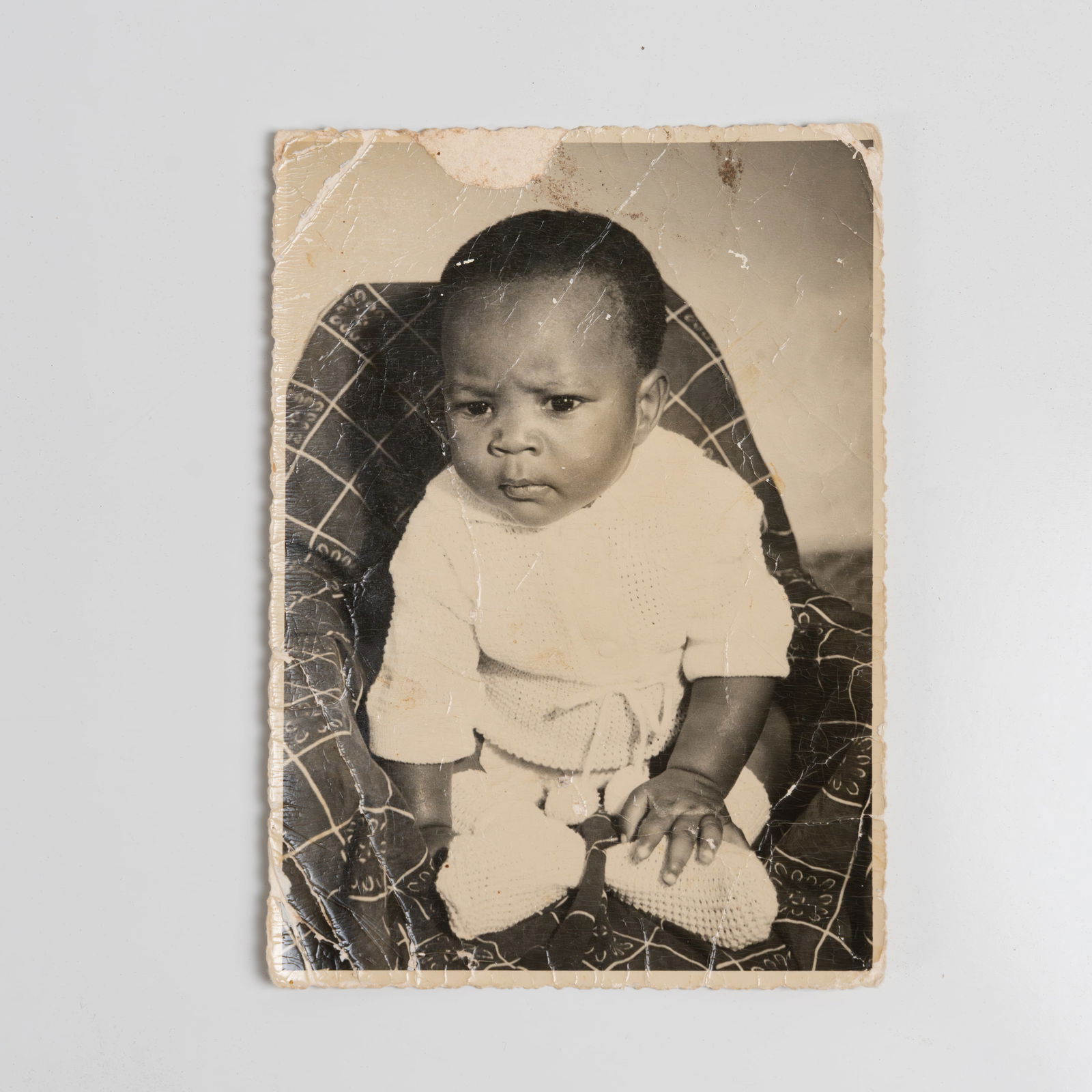 Malick Sidibe - Photograph of a Child: An original photograph of a baby by Malick Sidibe, Mali. Stamped on back and dated, June 1976. All measurements are in inches. Height x Width x Depth