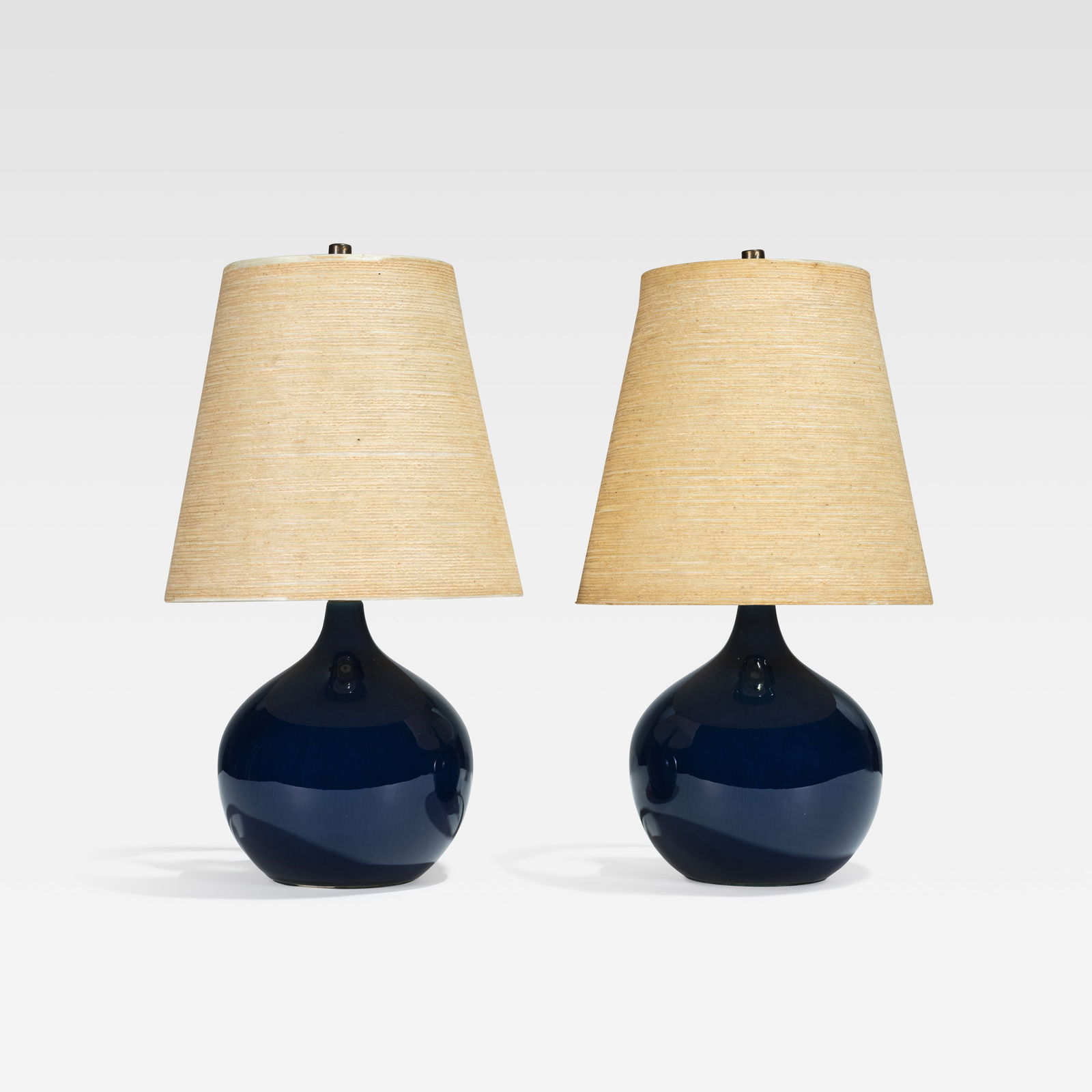 Lotte & Gunnar Bostlund - Ceramic Lamps: A pair of blue glazed ceramic lamps with original fiberglass shades by Lotte & Gunnar Bostlund. Dimensions include shade. All measurements are Height x Width x Depth.
