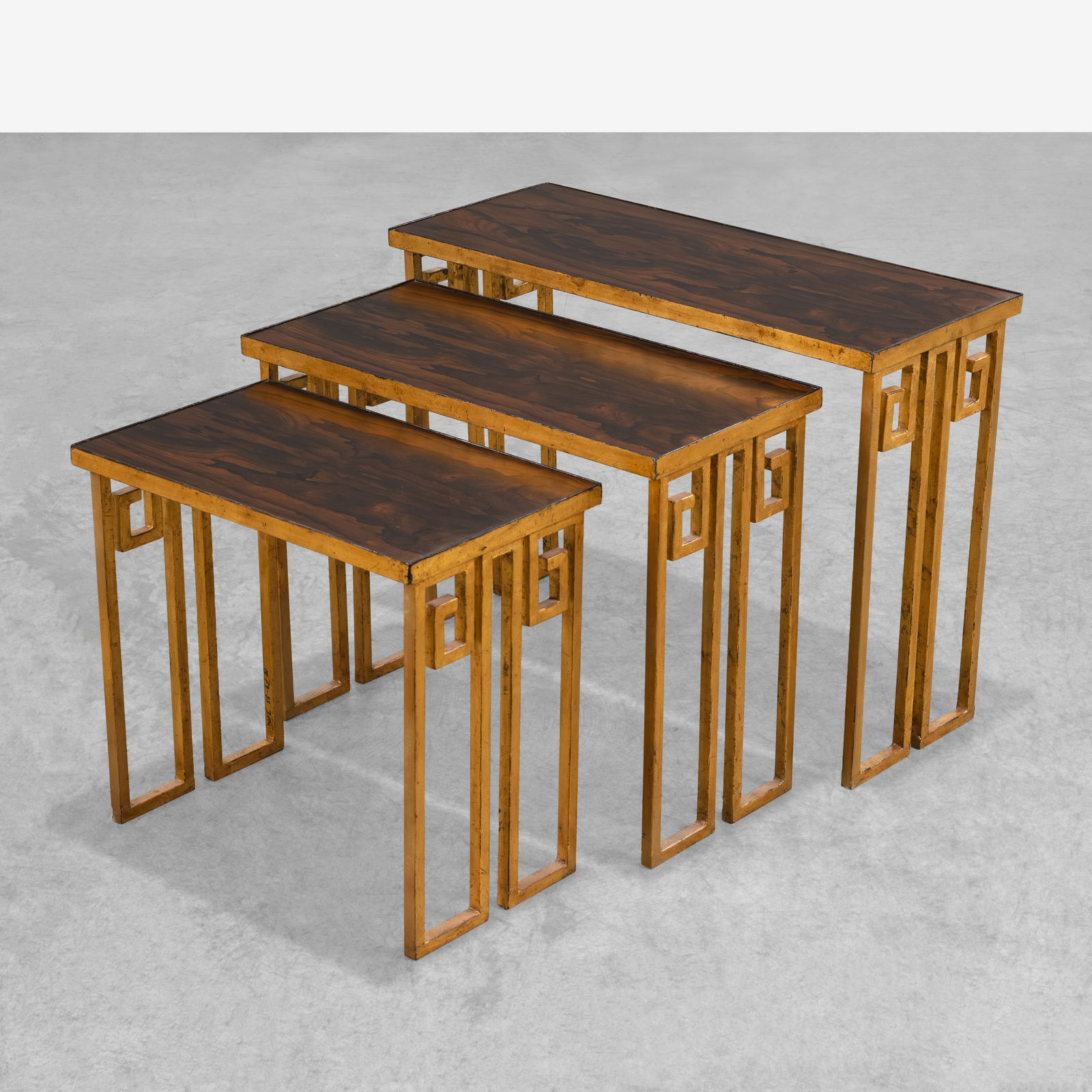 Jean Royere (After) - Nesting Tables: A set of three gilt metal and rosewood in the manner of Jean Royere. All measurements are Height x Width x Depth.