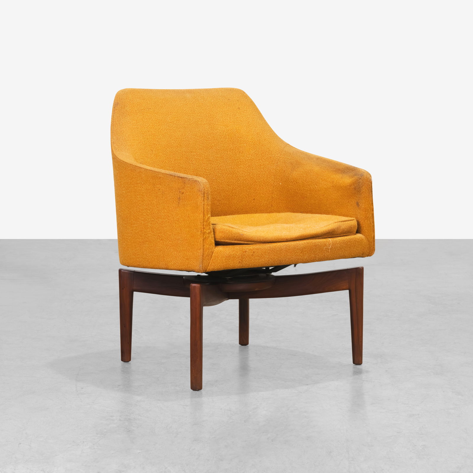 Jens Risom - Swiveling Armchair: A swiveling armchair on walnut base by Jens Risom. All measurements are Height x Width x Depth.