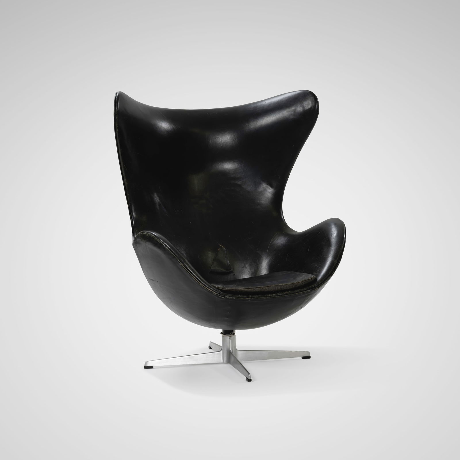 Arne Jacobsen - Egg Chair: A vintage 'Egg' chair by Arne Jacobsen for Fritz Hansen, Denmark in black leather. All measurements are Height x Width x Depth.