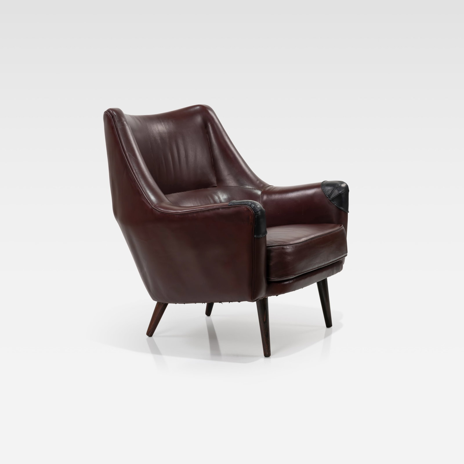 Ib Kofod Larsen - Lounge Chair: A leather and rosewood lounge chair by Ib Kofod Larsen for Harald Gjernoe. All measurements are Height x Width x Depth.