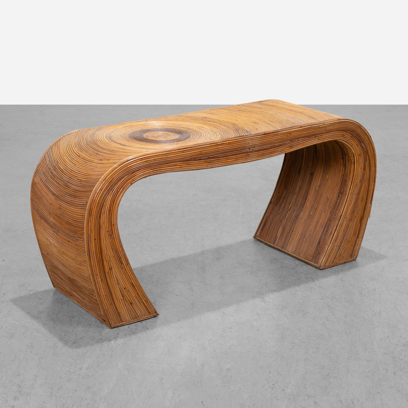 Pencil Rattan Console Table: A pencil rattan console table in the manner of Gabriella Crespi. All measurements are Height x Width x Depth.