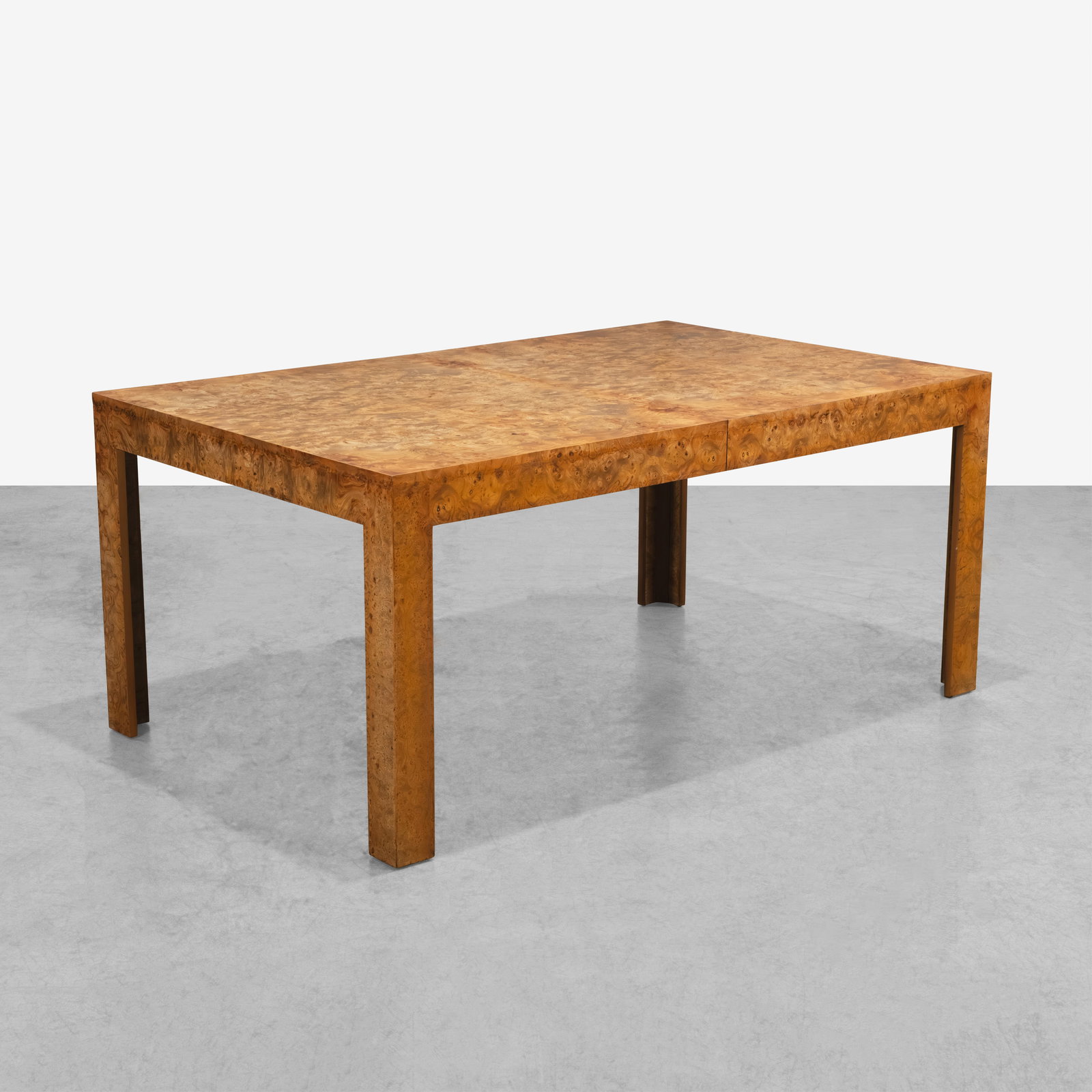 Burl Dining Table: A burl dining table with two leaves in the manner of Milo Baughman. Leaf - 18 each. All measurements are Height x Width x Depth.