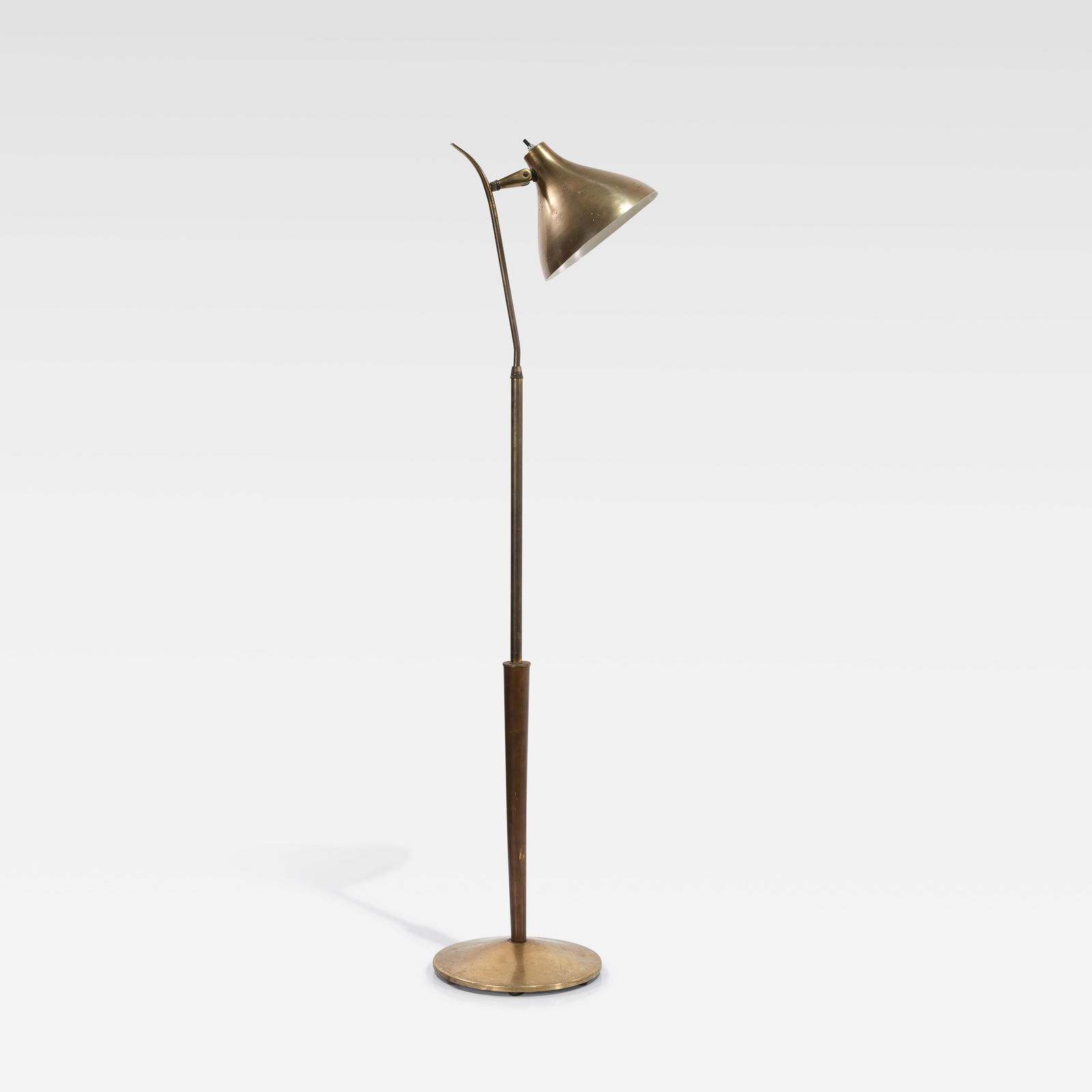 Paavo Tynell (After) - Floor Lamp: A vintage brass floor lamp with a pierced shade in the manner of Paavo Tynell. All measurements are Height x Width x Depth.
